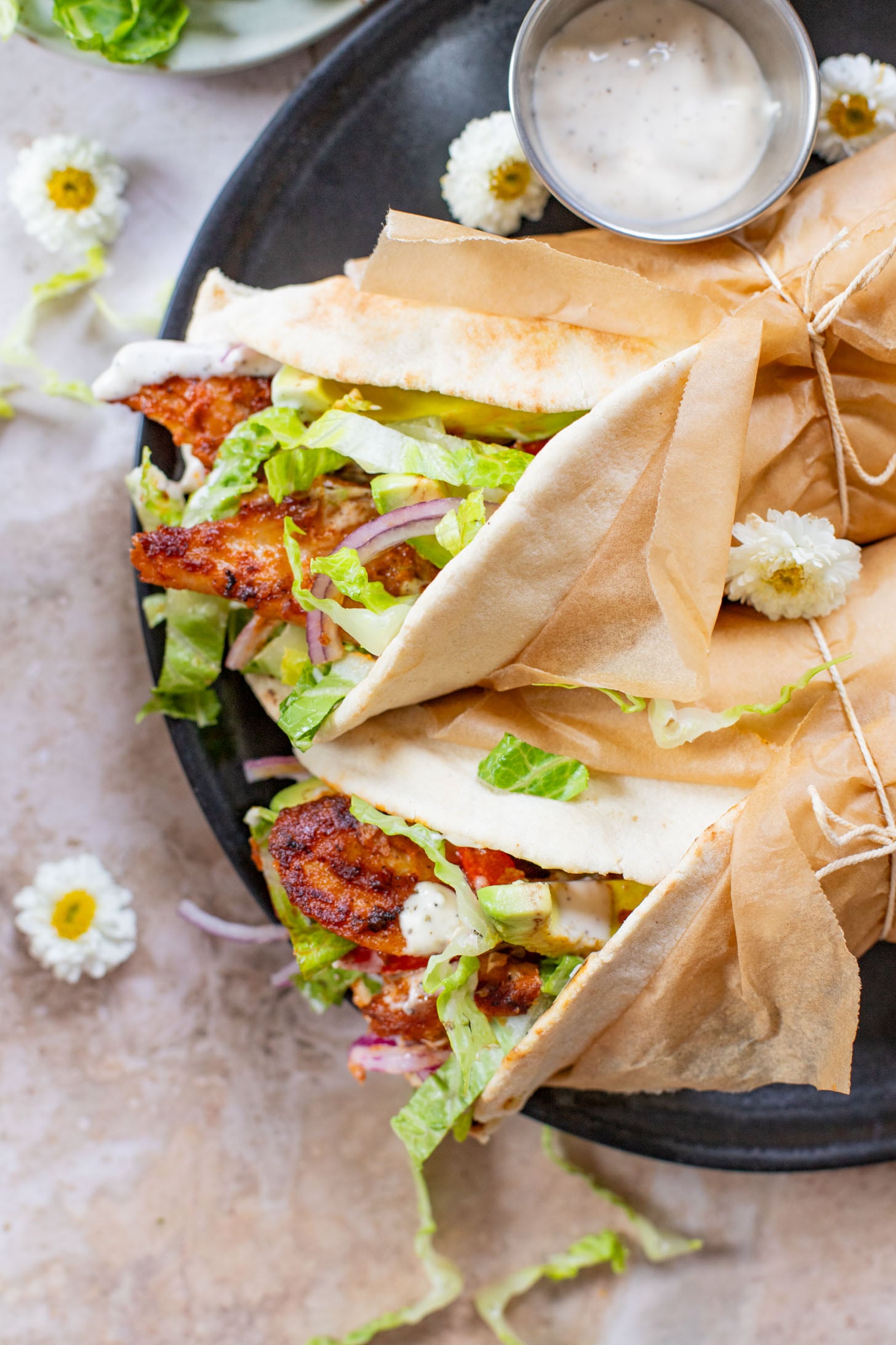 Skip going out to eat and make these Vegan Chipotle Chicken Pitas instead! Crispy vegan chicken with a lime aioli wrapped in a pita with veggies | ThisSavoryVegan.com