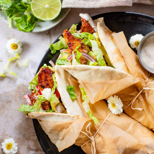 Skip going out to eat and make these Vegan Chipotle Chicken Pitas instead! Crispy vegan chicken with a lime aioli wrapped in a pita with veggies | ThisSavoryVegan.com
