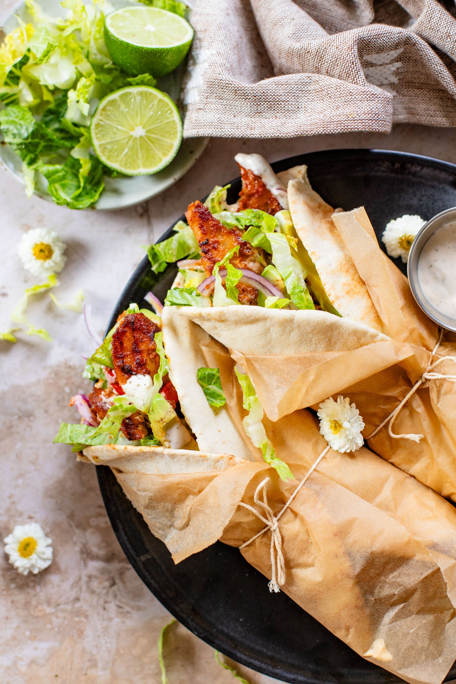 Skip going out to eat and make these Vegan Chipotle Chicken Pitas instead! Crispy vegan chicken with a lime aioli wrapped in a pita with veggies | ThisSavoryVegan.com