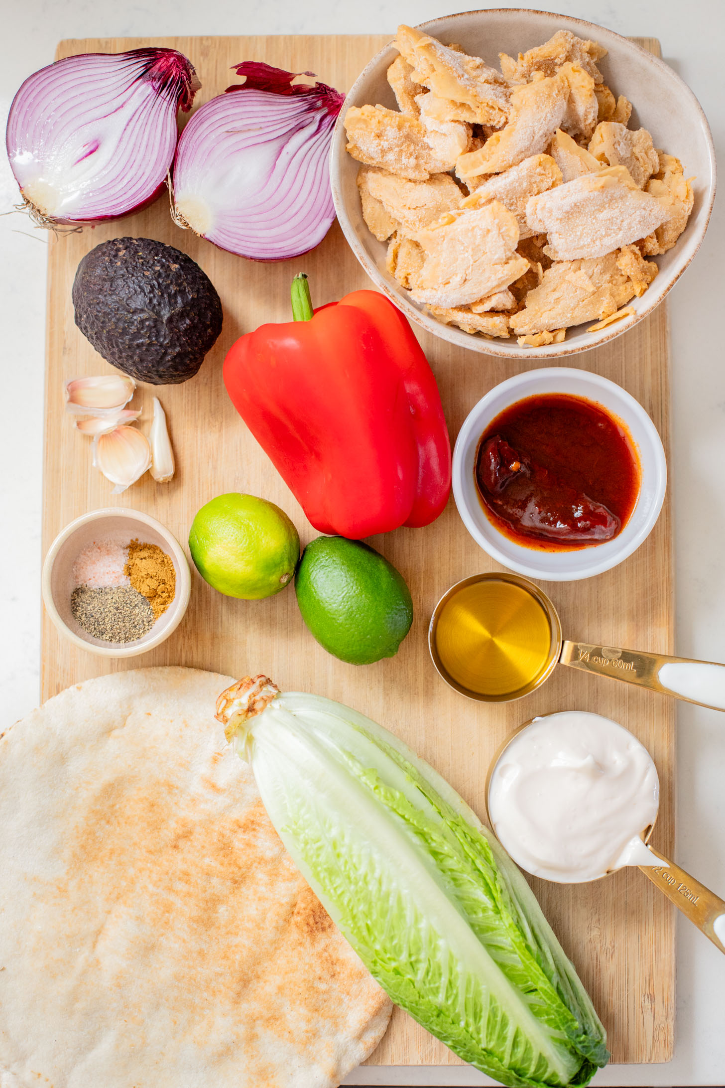 Skip going out to eat and make these Vegan Chipotle Chicken Pitas instead! Crispy vegan chicken with a lime aioli wrapped in a pita with veggies | ThisSavoryVegan.com