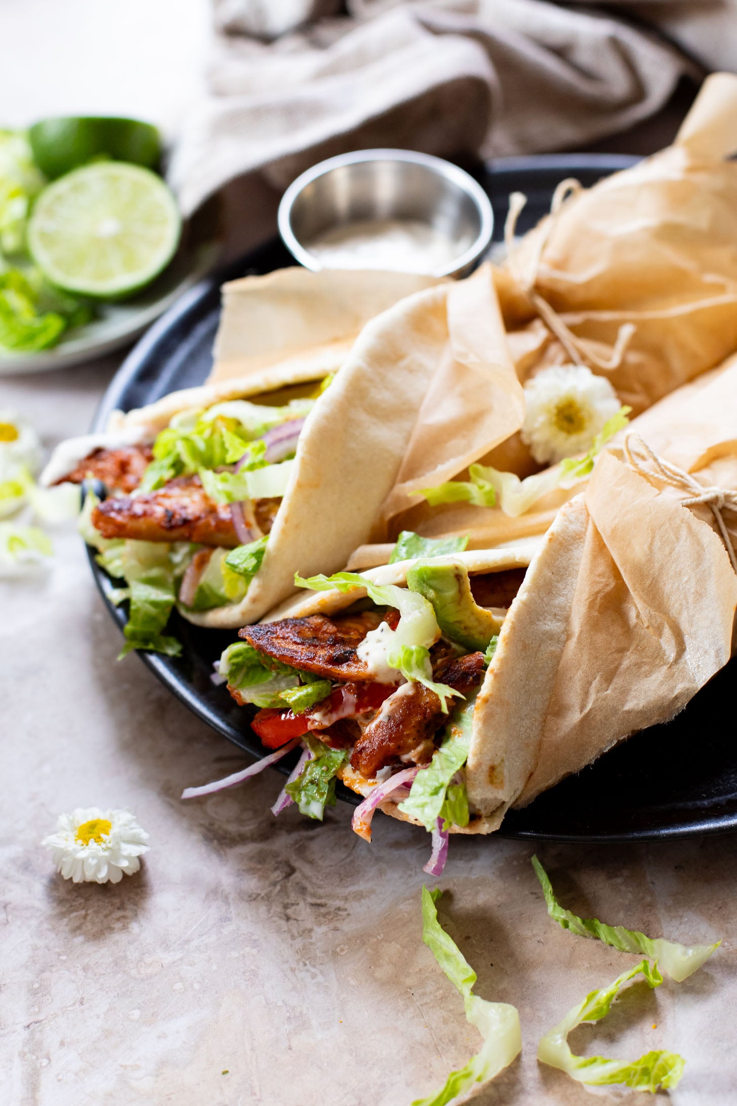 Skip going out to eat and make these Vegan Chipotle Chicken Pitas instead! Crispy vegan chicken with a lime aioli wrapped in a pita with veggies | ThisSavoryVegan.com