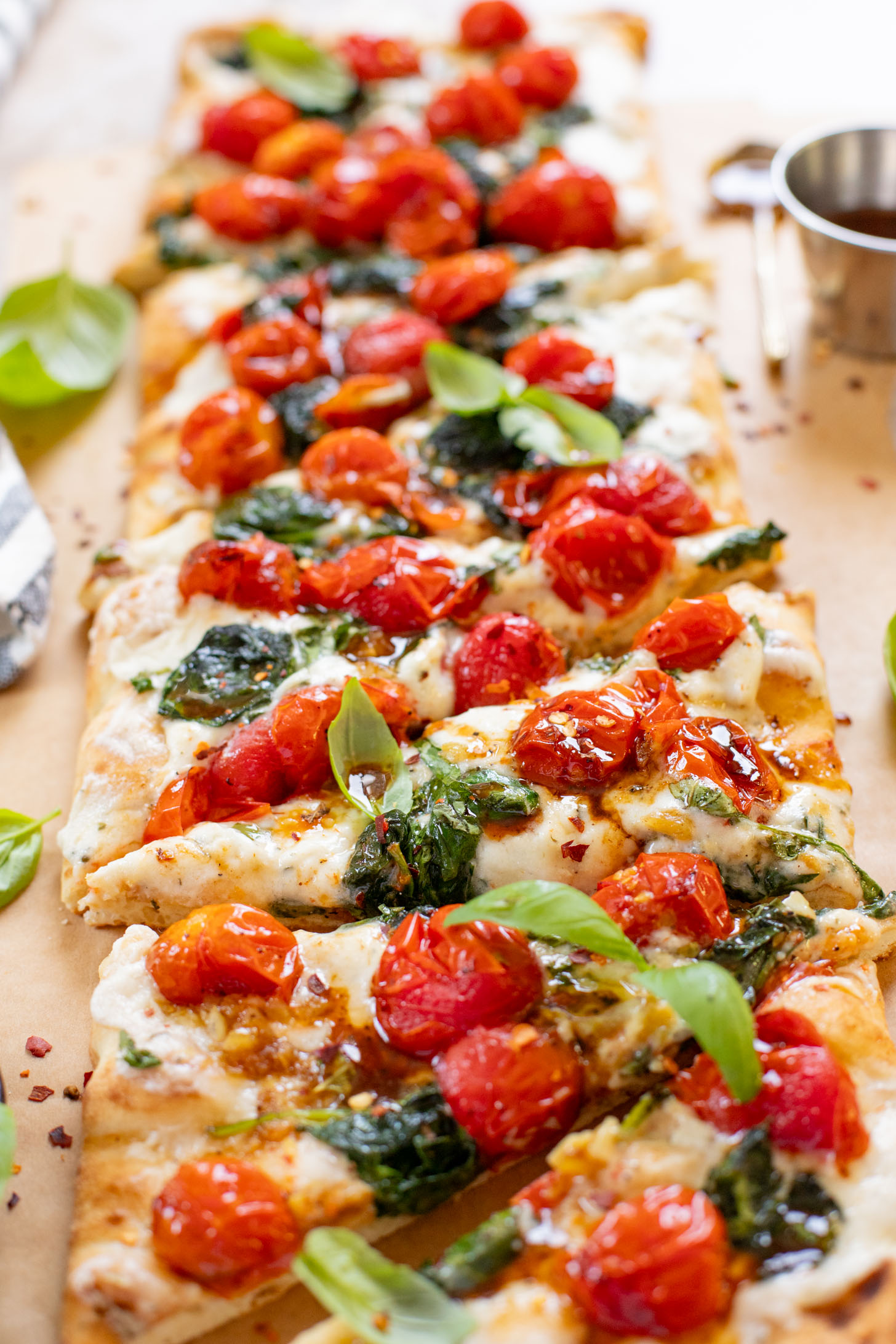 This Burst Tomato Flatbread is a delicious summer recipe! Made with dairy-free cheese and topped with balsamic burst cherry tomatoes | ThisSavoryVegan.com