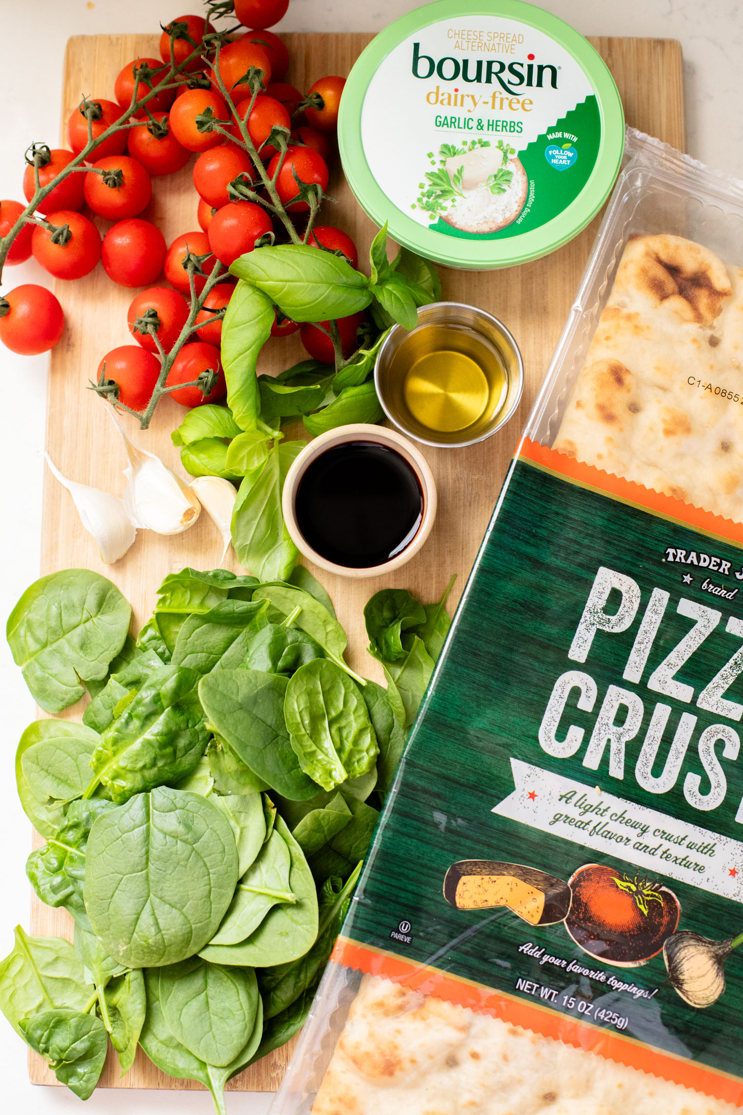 This Burst Tomato Flatbread is a delicious summer recipe! Made with dairy-free cheese and topped with balsamic burst cherry tomatoes | ThisSavoryVegan.com