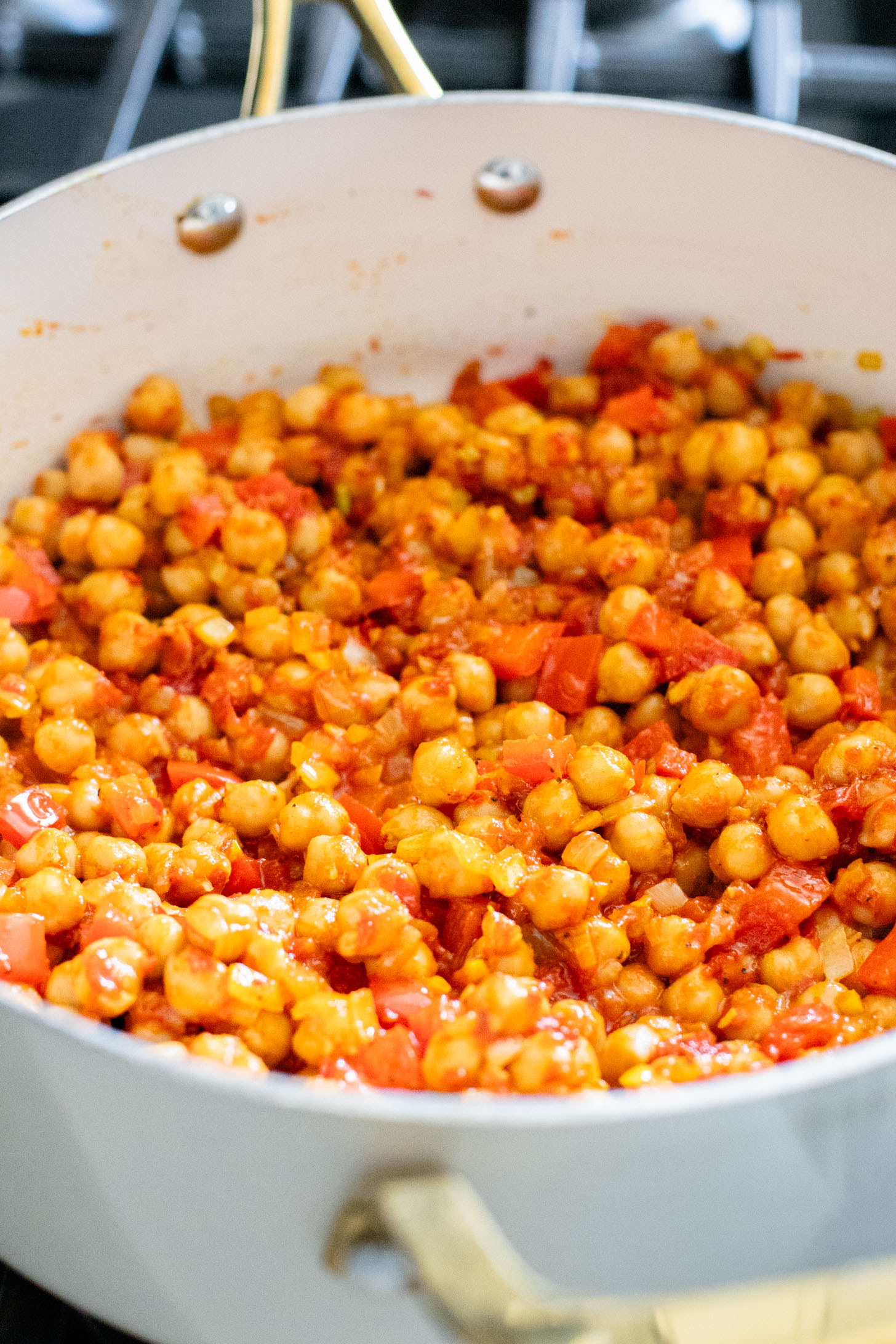 This Coconut Harissa Chickpea Skillet is an easy weeknight dinner that is dairy-free and packs in veggies & plant protein in a creamy sauce | ThisSavoryVegan.com