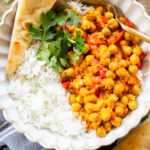 This Coconut Harissa Chickpea Skillet is an easy weeknight dinner that is dairy-free and packs in veggies & plant protein in a creamy sauce | ThisSavoryVegan.com