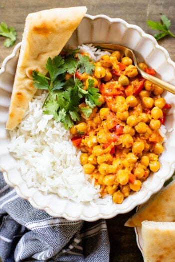 This Coconut Harissa Chickpea Skillet is an easy weeknight dinner that is dairy-free and packs in veggies & plant protein in a creamy sauce | ThisSavoryVegan.com