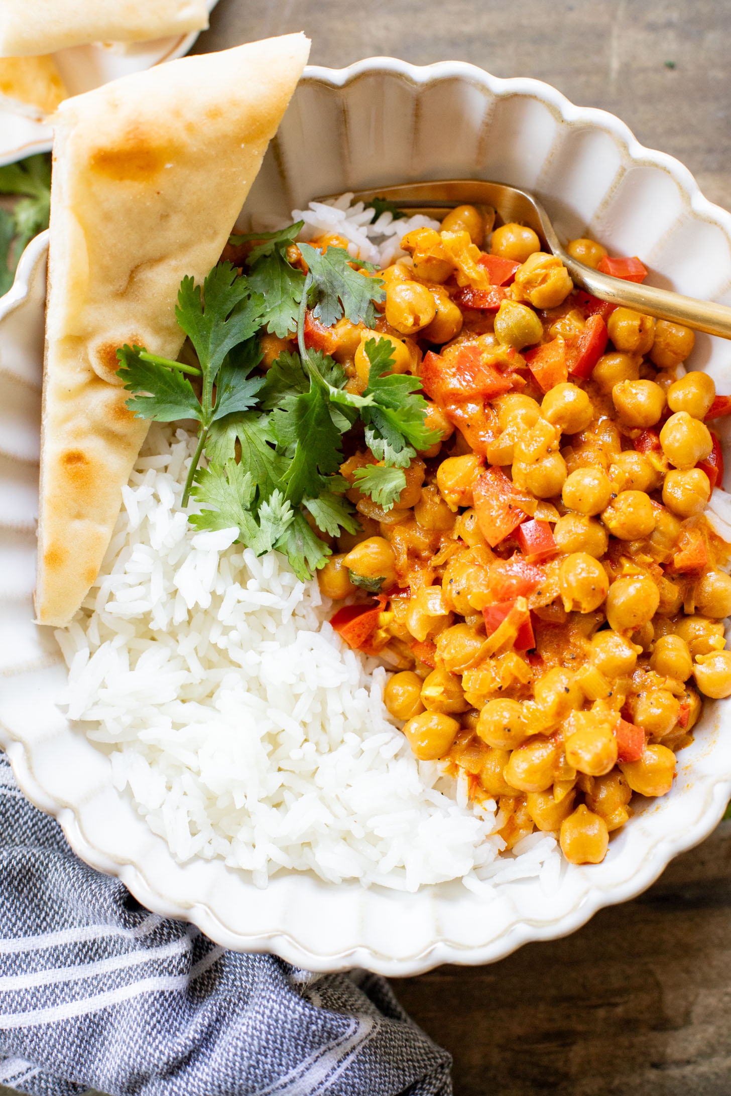 This Coconut Harissa Chickpea Skillet is an easy weeknight dinner that is dairy-free and packs in veggies & plant protein in a creamy sauce | ThisSavoryVegan.com