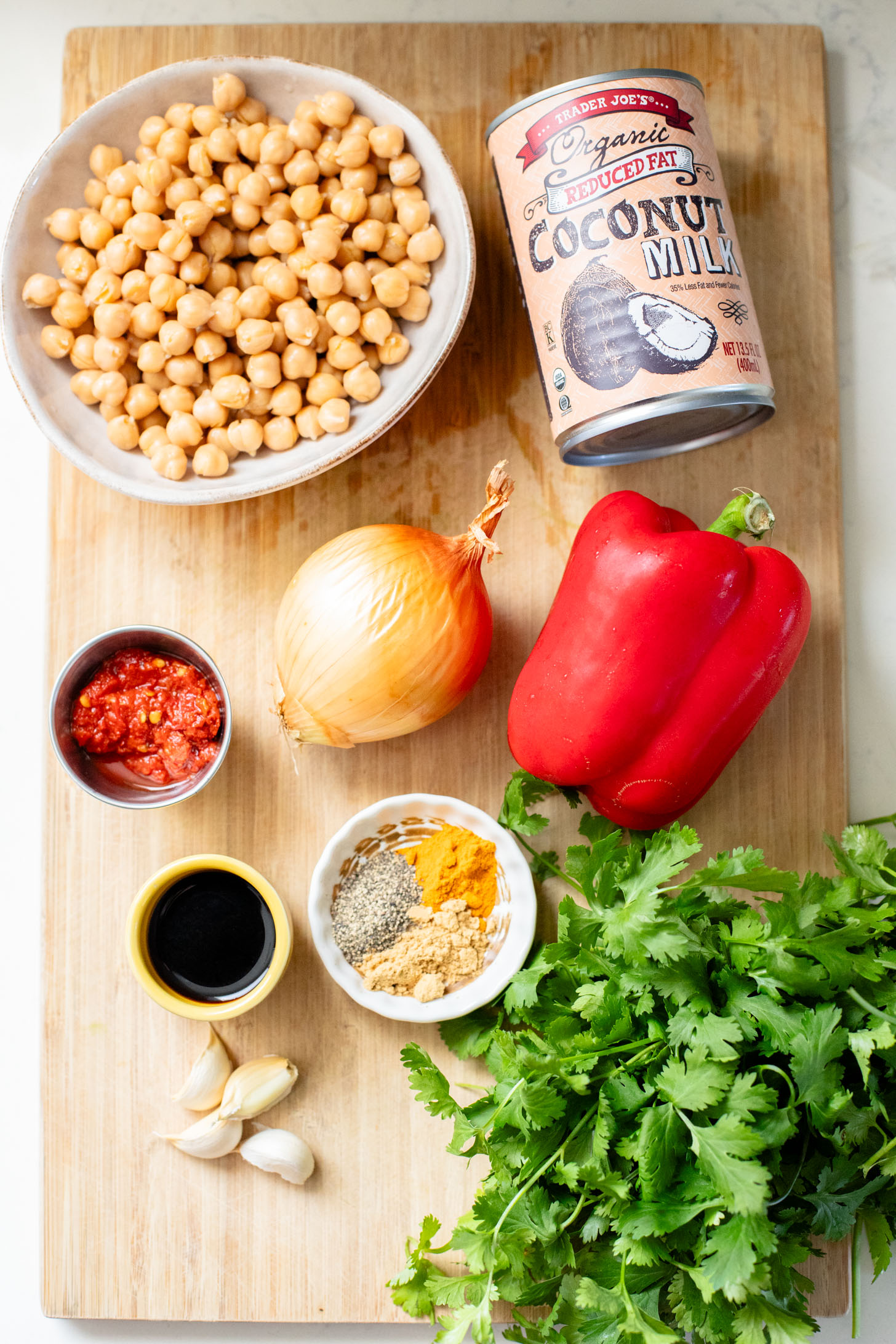 This Coconut Harissa Chickpea Skillet is an easy weeknight dinner that is dairy-free and packs in veggies & plant protein in a creamy sauce | ThisSavoryVegan.com