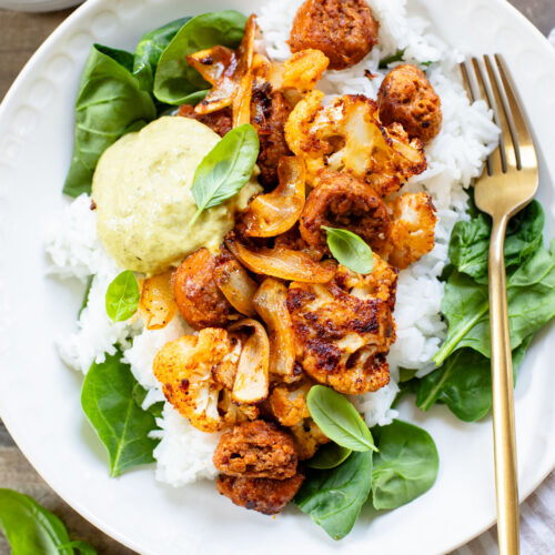 This Sheet Pan Vegan Sausage & Cauliflower is the perfect weeknight dinner. Served over rice with a pesto aioli | ThisSavoryVegan.com