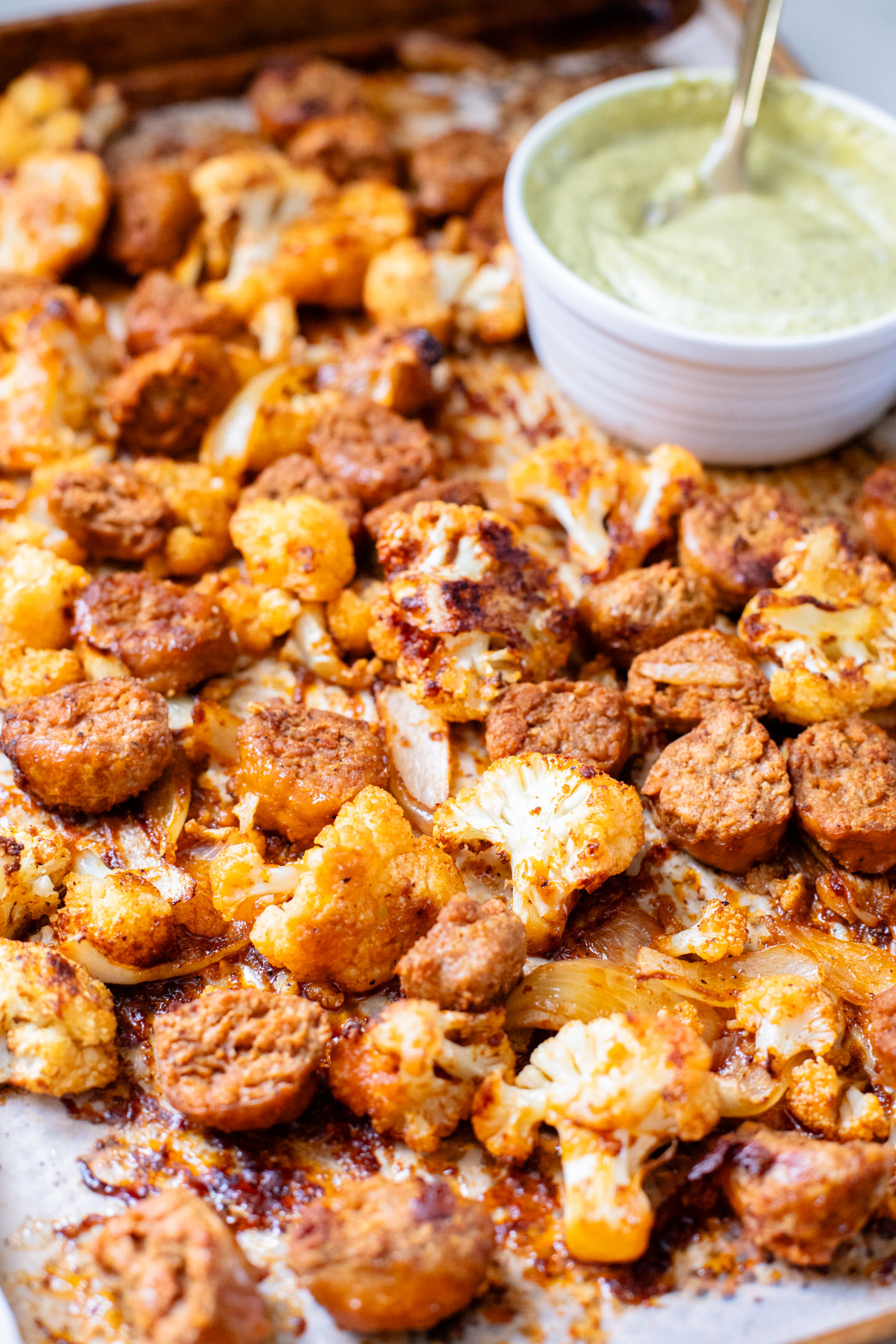 This Sheet Pan Vegan Sausage & Cauliflower is the perfect weeknight dinner. Served over rice with a pesto aioli | ThisSavoryVegan.com
