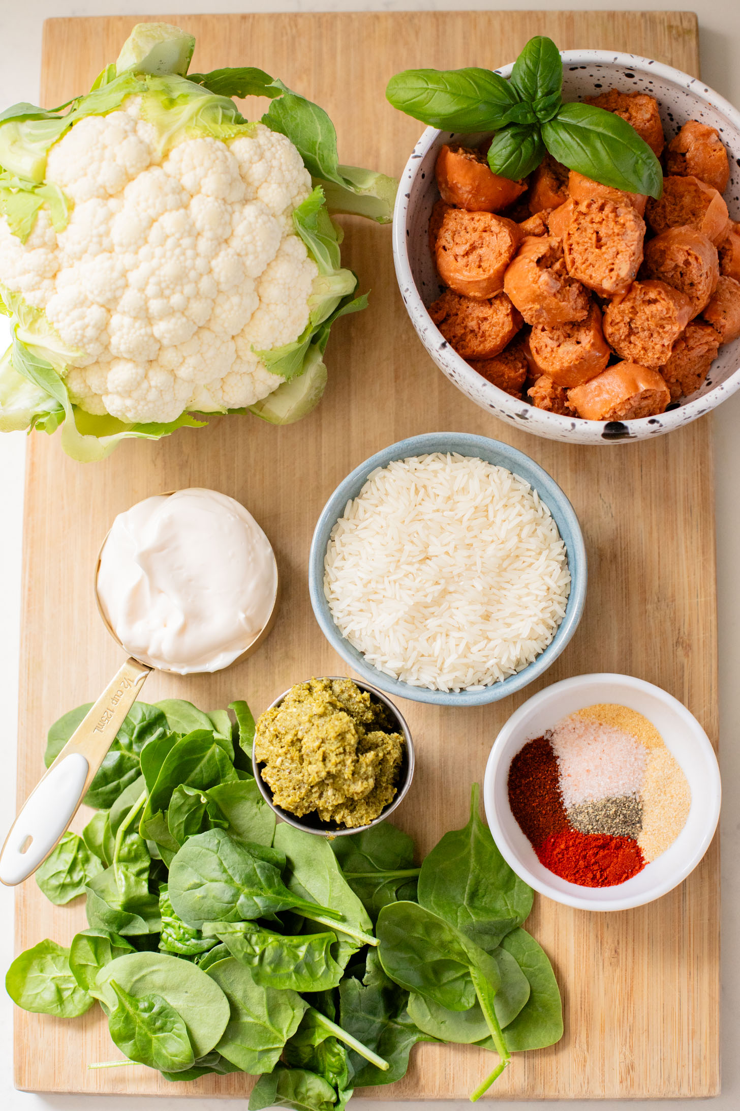 This Sheet Pan Vegan Sausage & Cauliflower is the perfect weeknight dinner. Served over rice with a pesto aioli | ThisSavoryVegan.com