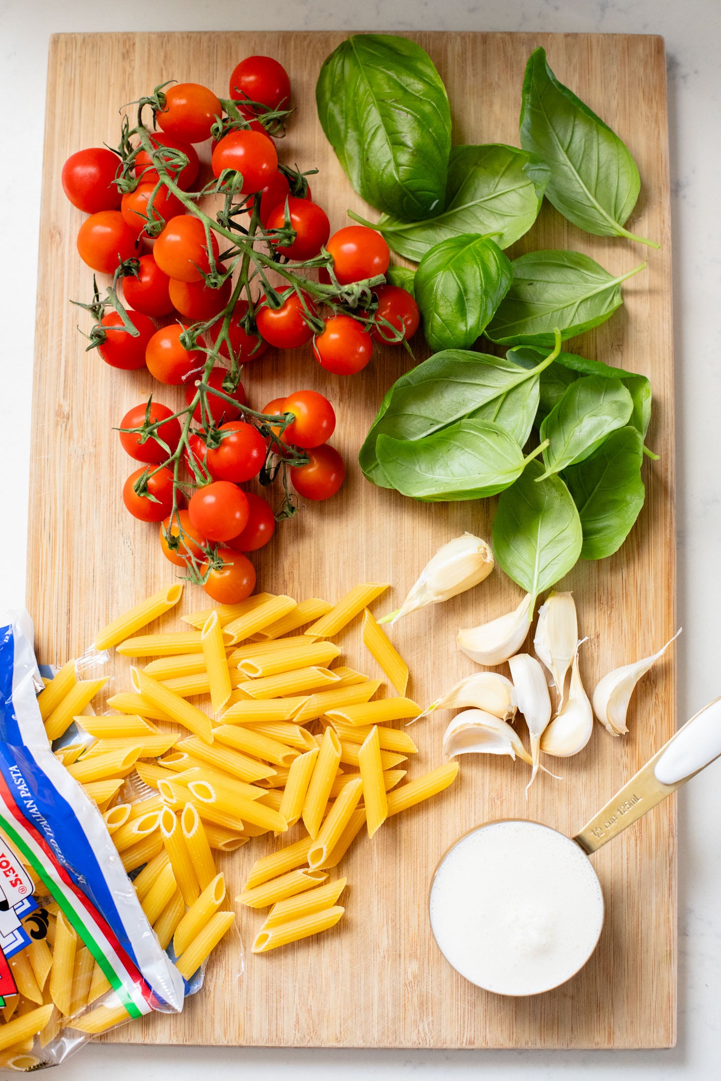 This 5-Ingredient Tomato Basil Penne is a quick, one-pot dinner! The cherry tomatoes & dairy-free cream make the best pasta sauce | ThisSavoryVegan.com