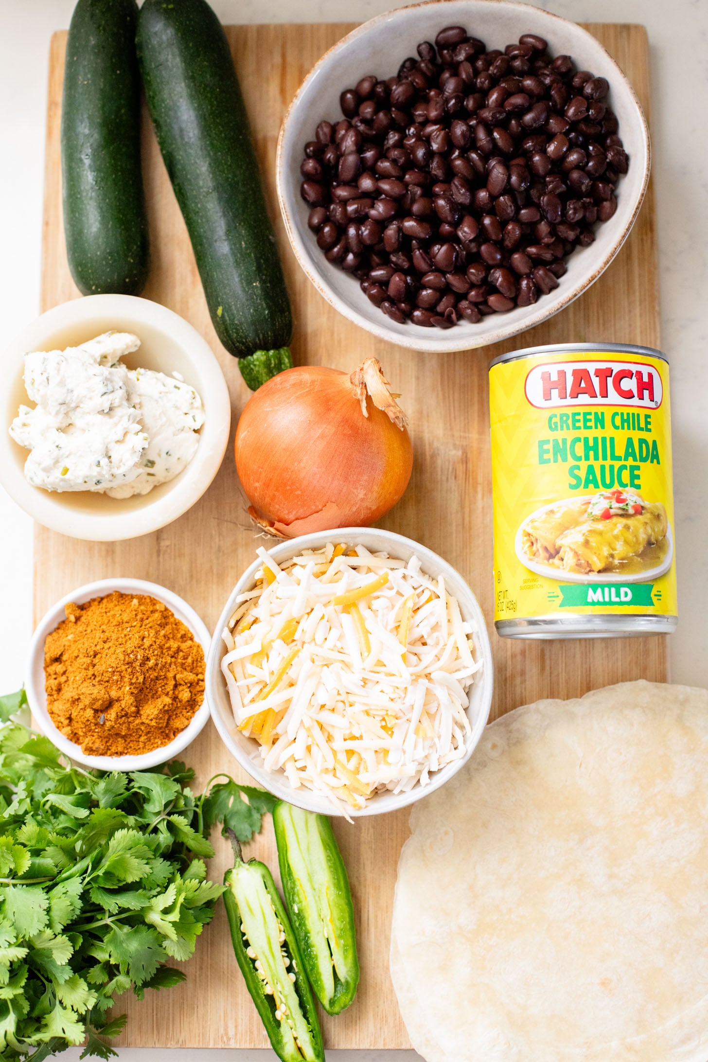These Black Bean & Zucchini Enchiladas are the perfect way to use up summer zucchini. These enchiladas are dairy-free and delicious | ThisSavoryVegan.com