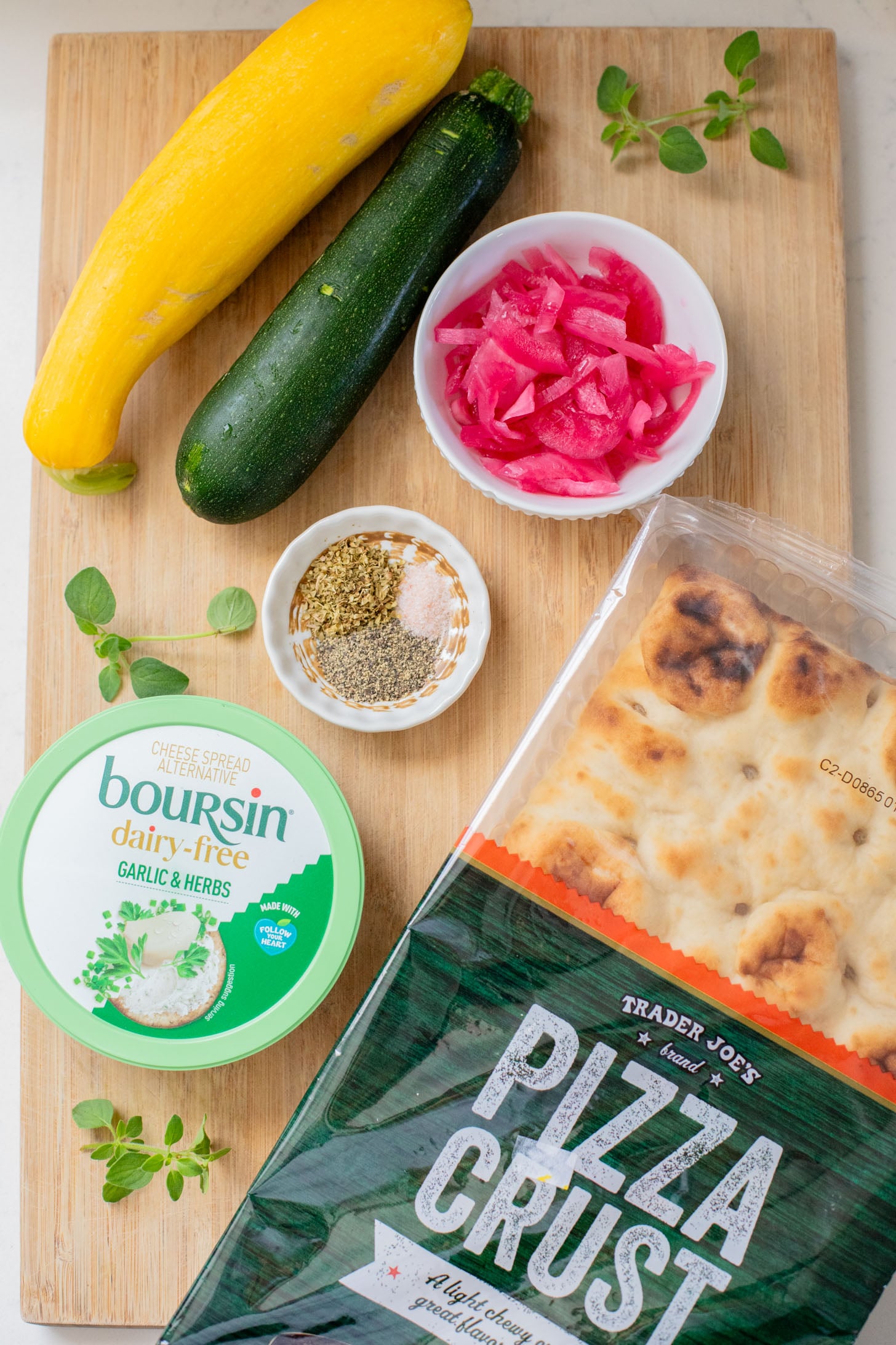 A yummy summer appetizer or quick dinner - this Cheesy Zucchini Flatbread is made with dairy-free cheese and zucchini slices | ThisSavoryVegan.com