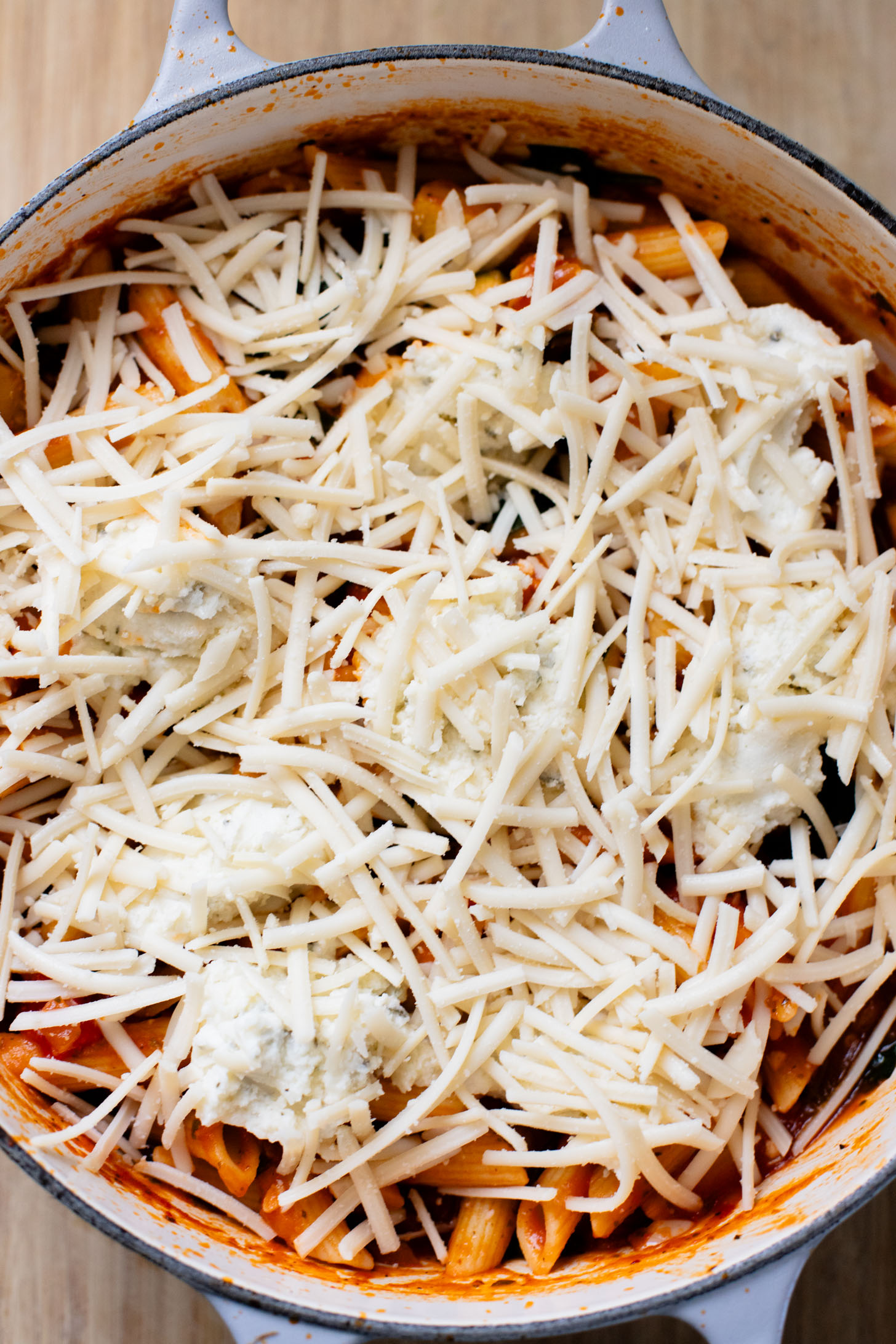 This Cheesy Zucchini Penne is a one-pot, dairy-free dinner! Packed with summer squash, marinara and a cheesy topping | ThisSavoryVegan.com