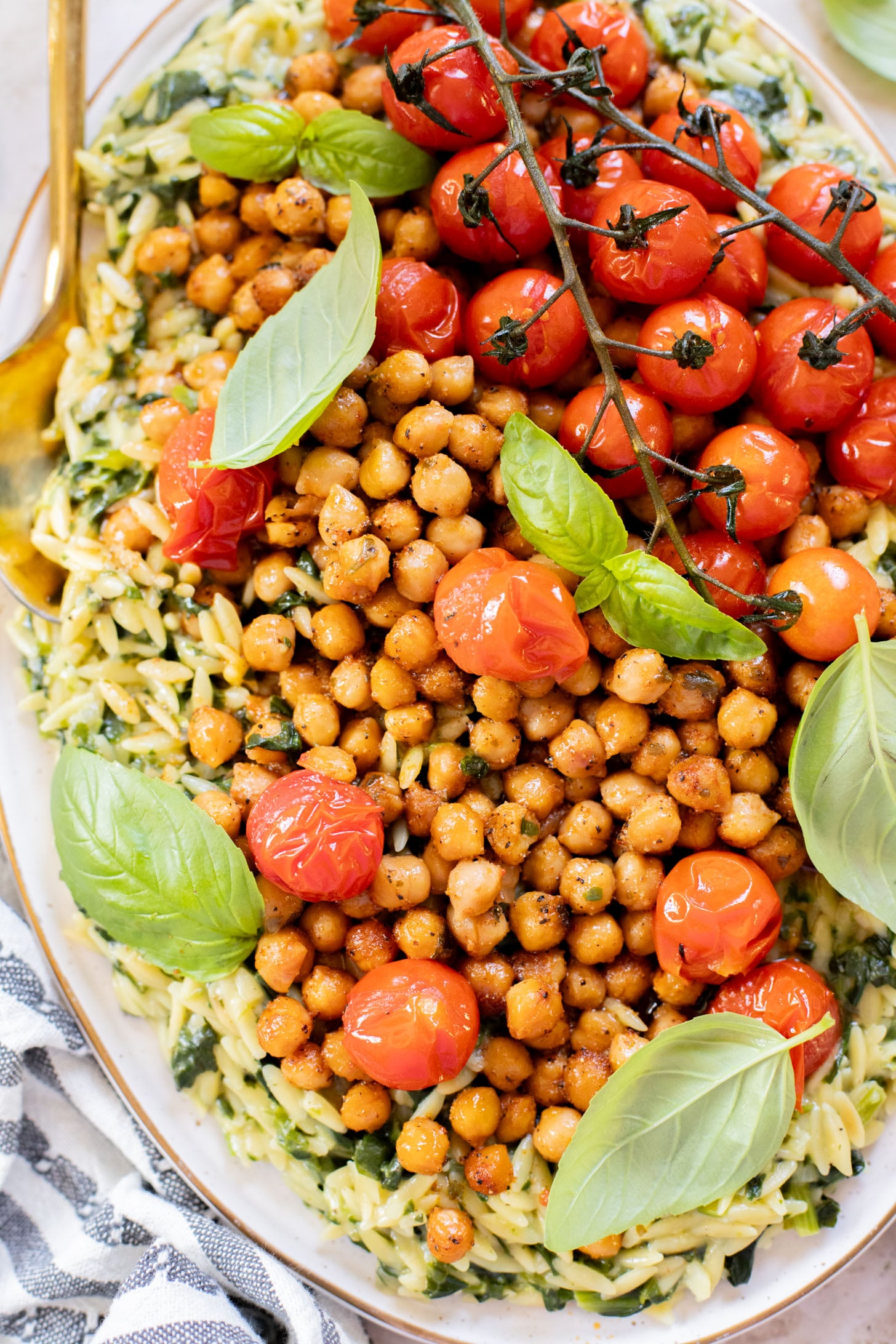 This Creamy Spinach Orzo with Burst Tomatoes is dairy-free and packed with summer flavors. A tasty side dish or main | ThisSavoryVegan.com