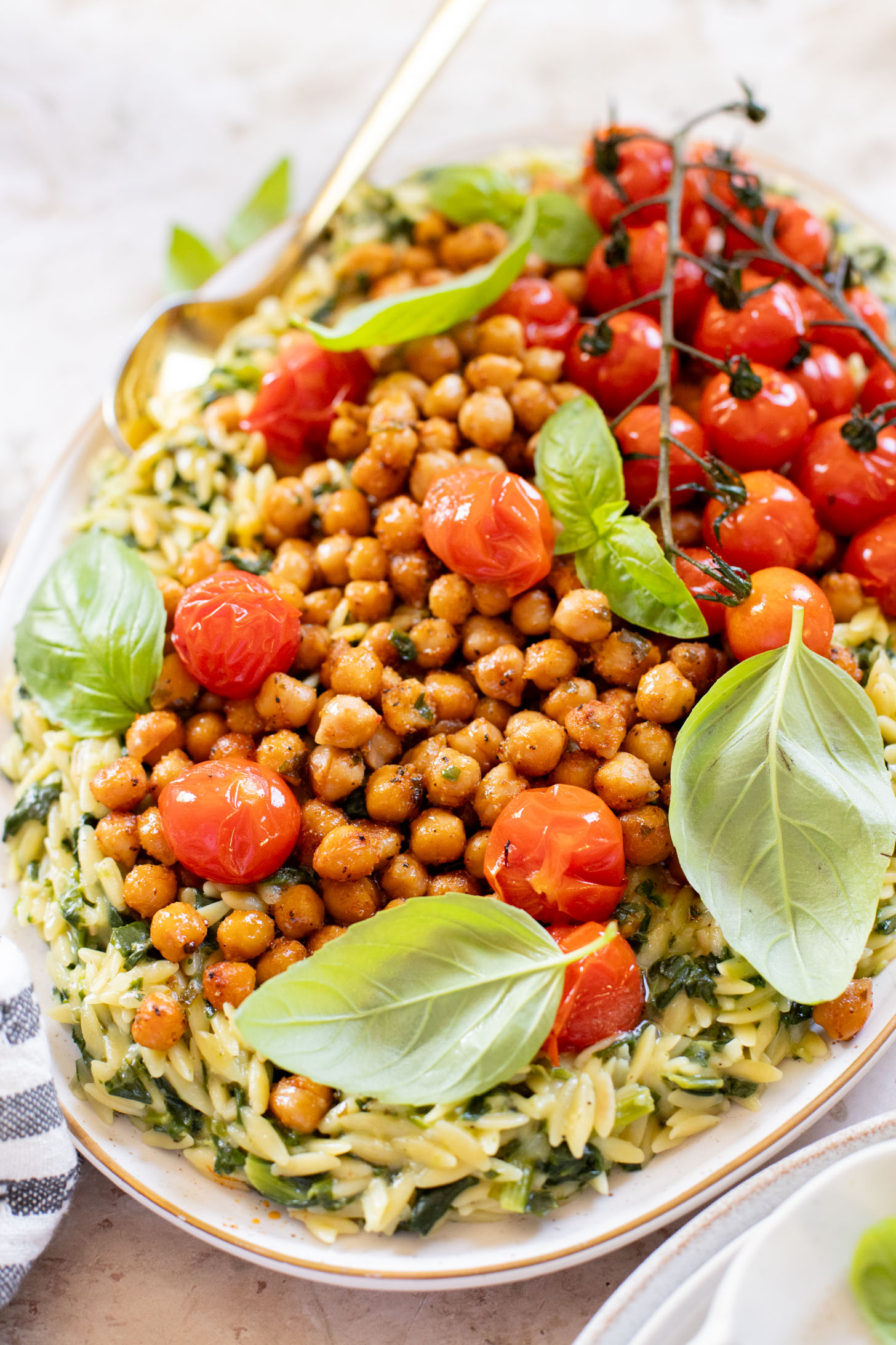 This Creamy Spinach Orzo with Burst Tomatoes is dairy-free and packed with summer flavors. A tasty side dish or main | ThisSavoryVegan.com