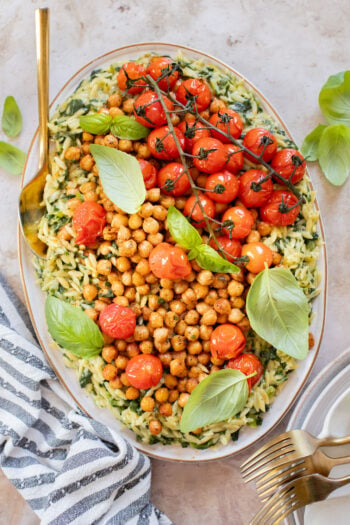 This Creamy Spinach Orzo with Burst Tomatoes is dairy-free and packed with summer flavors. A tasty side dish or main | ThisSavoryVegan.com