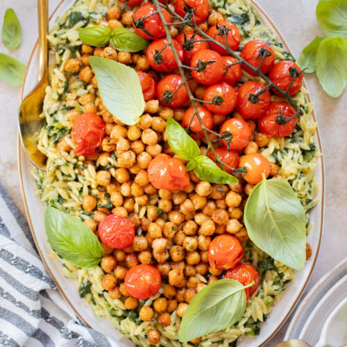 This Creamy Spinach Orzo with Burst Tomatoes is dairy-free and packed with summer flavors. A tasty side dish or main | ThisSavoryVegan.com