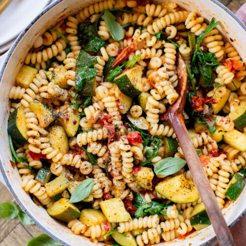 This One-Pot Summer Veggie Pasta is ready in 30 minutes and is filled with zucchini, tomatoes, greens & basil. Simple & delicious vegan pasta | ThisSavoryVegan.com