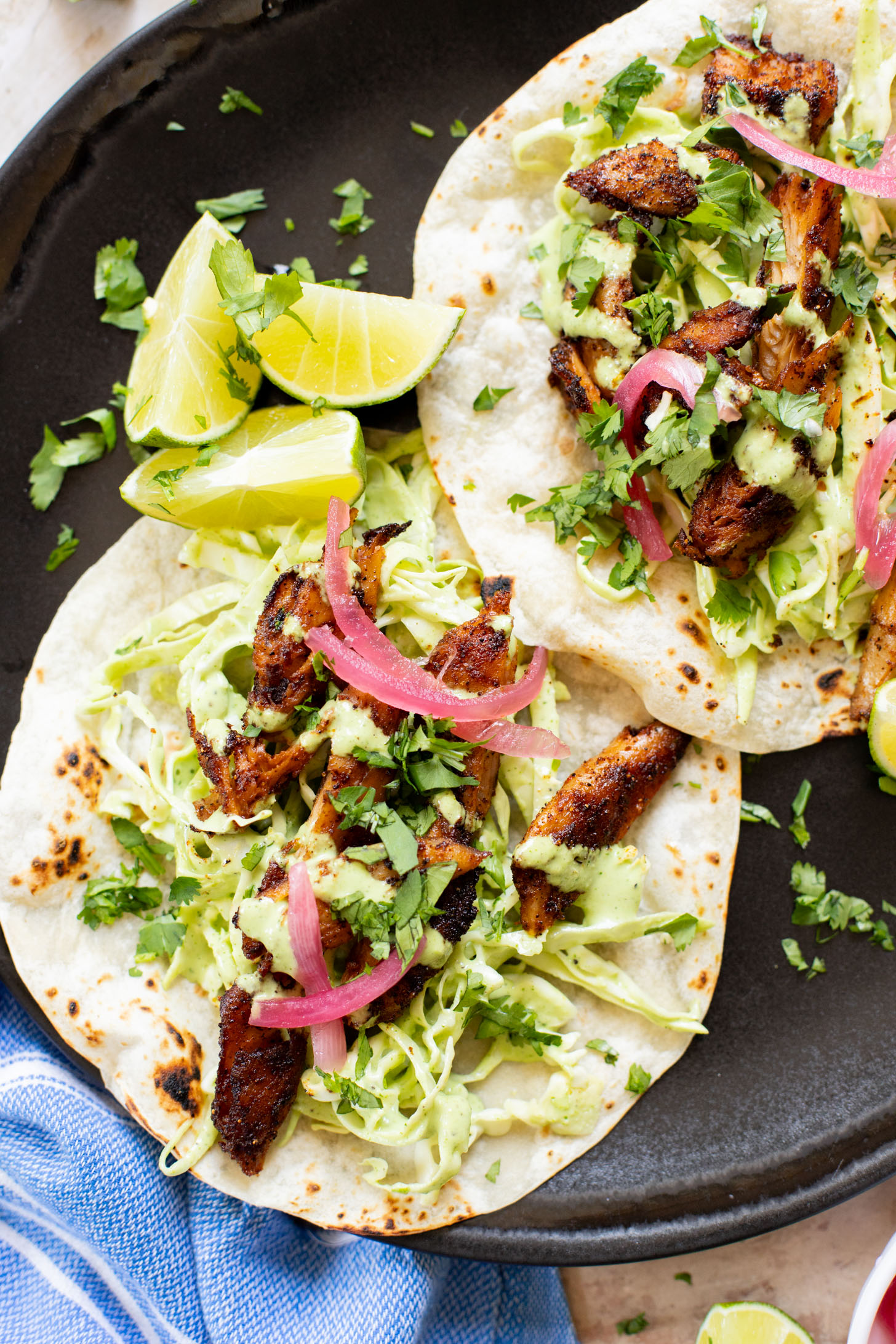 These Vegan Chicken Tacos are a must make! The vegan chicken is smoky & charred and the tacos are topped with a jalapeño cilantro sauce | ThisSavoryVegan.com