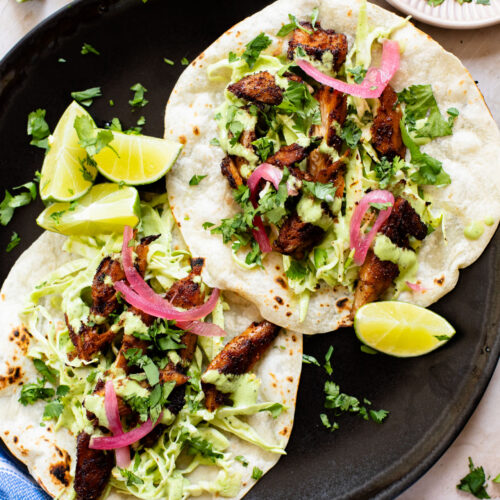 These Vegan Chicken Tacos are a must make! The vegan chicken is smoky & charred and the tacos are topped with a jalapeño cilantro sauce | ThisSavoryVegan.com