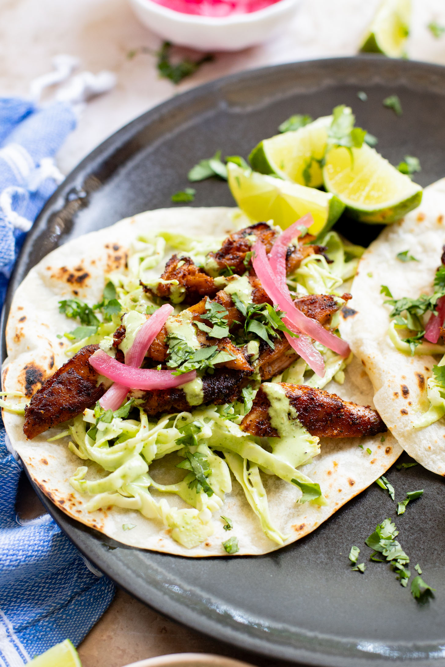 These Vegan Chicken Tacos are a must make! The vegan chicken is smoky & charred and the tacos are topped with a jalapeño cilantro sauce | ThisSavoryVegan.com