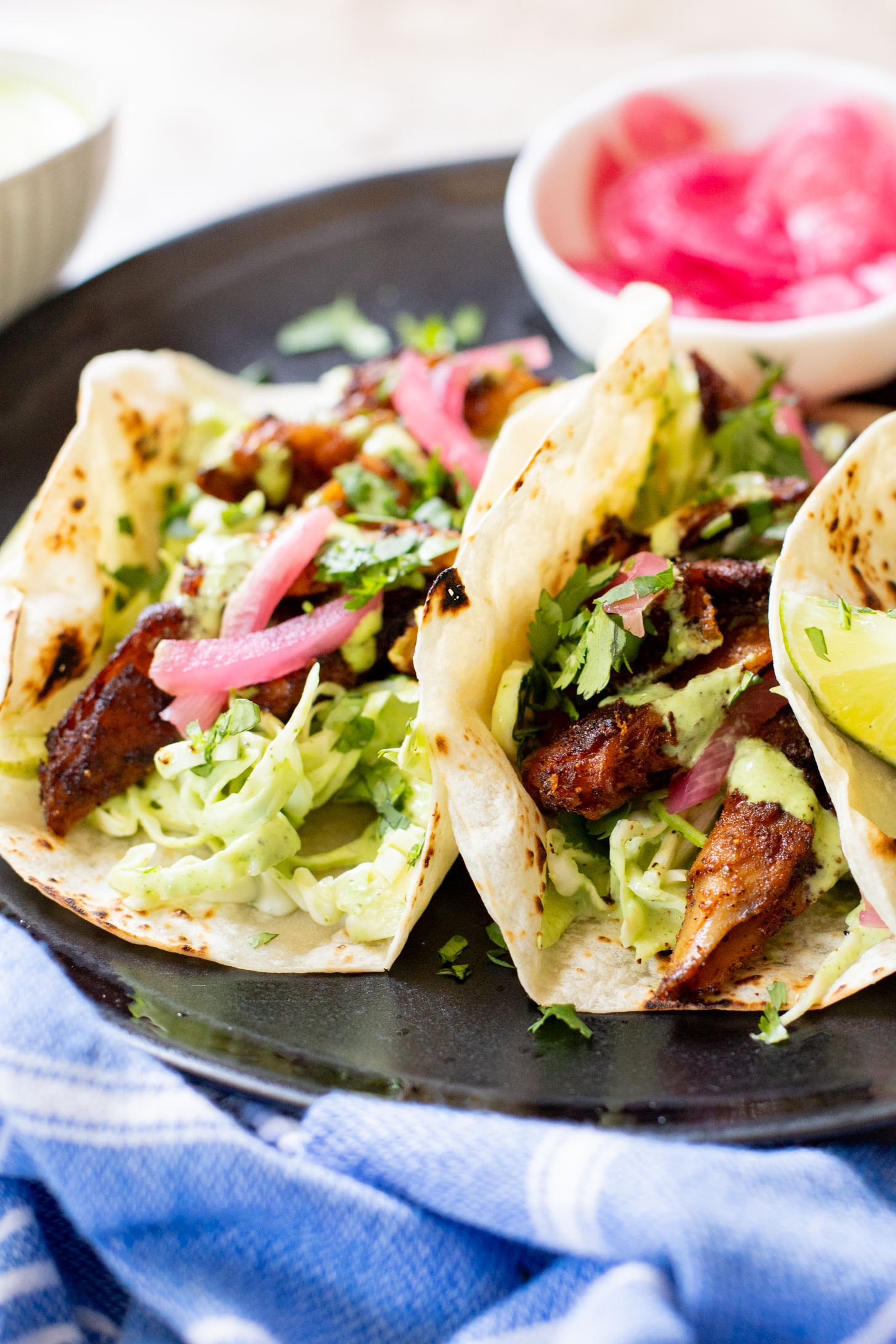 These Vegan Chicken Tacos are a must make! The vegan chicken is smoky & charred and the tacos are topped with a jalapeño cilantro sauce | ThisSavoryVegan.com