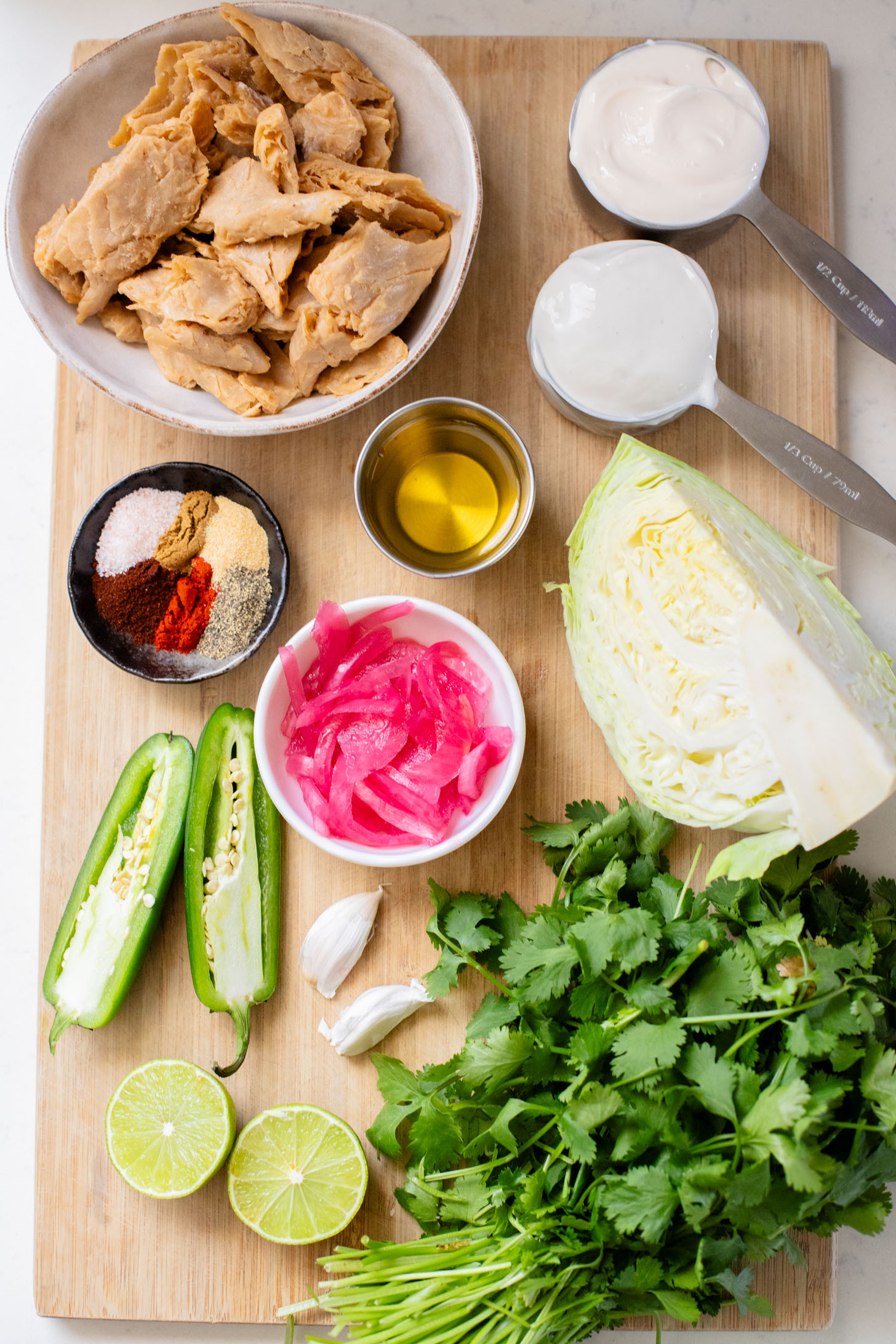 These Vegan Chicken Tacos are a must make! The vegan chicken is smoky & charred and the tacos are topped with a jalapeño cilantro sauce | ThisSavoryVegan.com