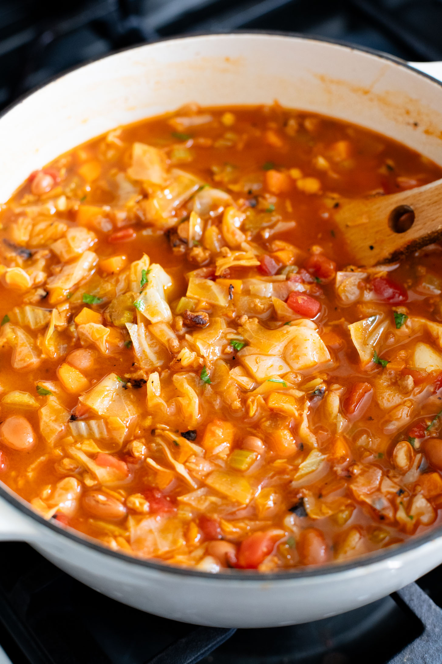 This Smoky Cabbage Soup is a healthy blend of tender cabbage, pinto beans & soy chorizo. Plant-based soup that is easy & delicious | ThisSavoryVegan.com