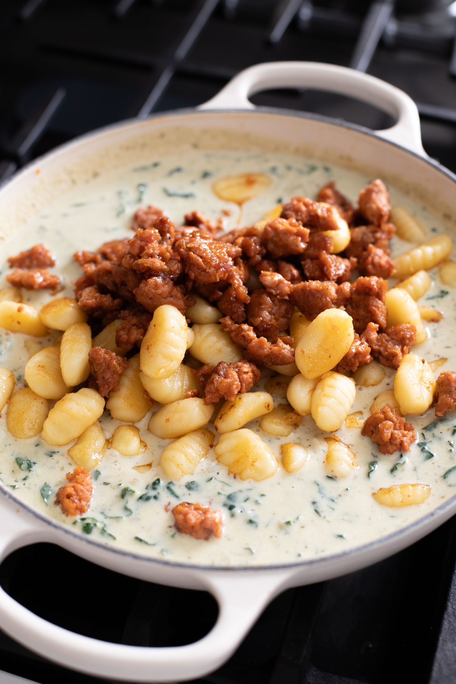 This Vegan Baked Sausage & Kale Gnocchi is a cheesy, comfort food dish. Made in one pot and baked until hot & bubbly | ThisSavoryVegan.com