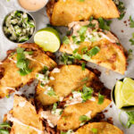 These Cheesy Bean Tacos are the perfect family weeknight dinner. Tortillas are stuffed with dairy-free cheese & beans and baked until crispy | ThisSavoryVegan.com