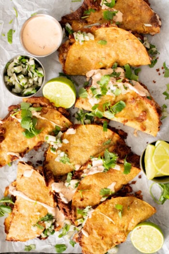 These Cheesy Bean Tacos are the perfect family weeknight dinner. Tortillas are stuffed with dairy-free cheese & beans and baked until crispy | ThisSavoryVegan.com