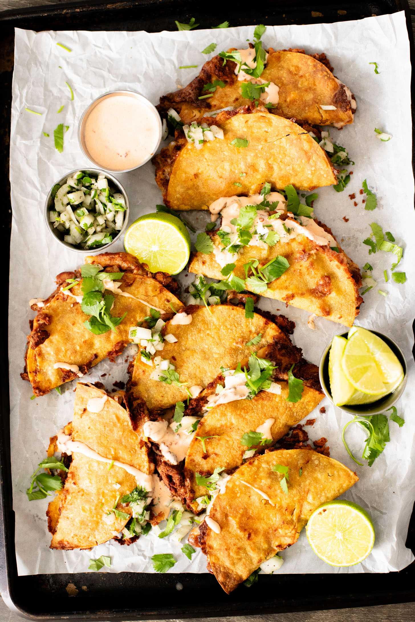 These Cheesy Bean Tacos are the perfect family weeknight dinner. Tortillas are stuffed with dairy-free cheese & beans and baked until crispy | ThisSavoryVegan.com