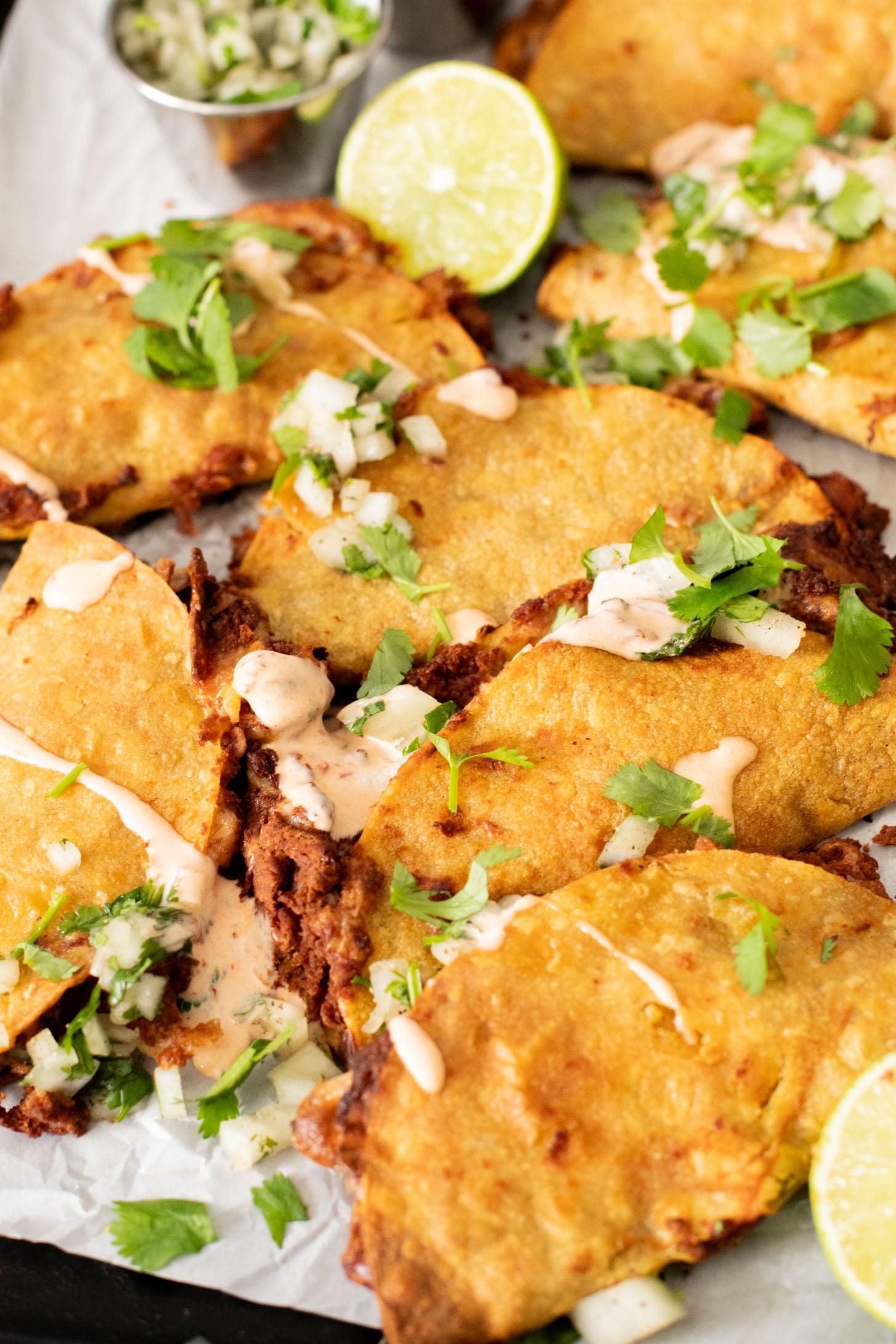These Cheesy Bean Tacos are the perfect family weeknight dinner. Tortillas are stuffed with dairy-free cheese & beans and baked until crispy | ThisSavoryVegan.com