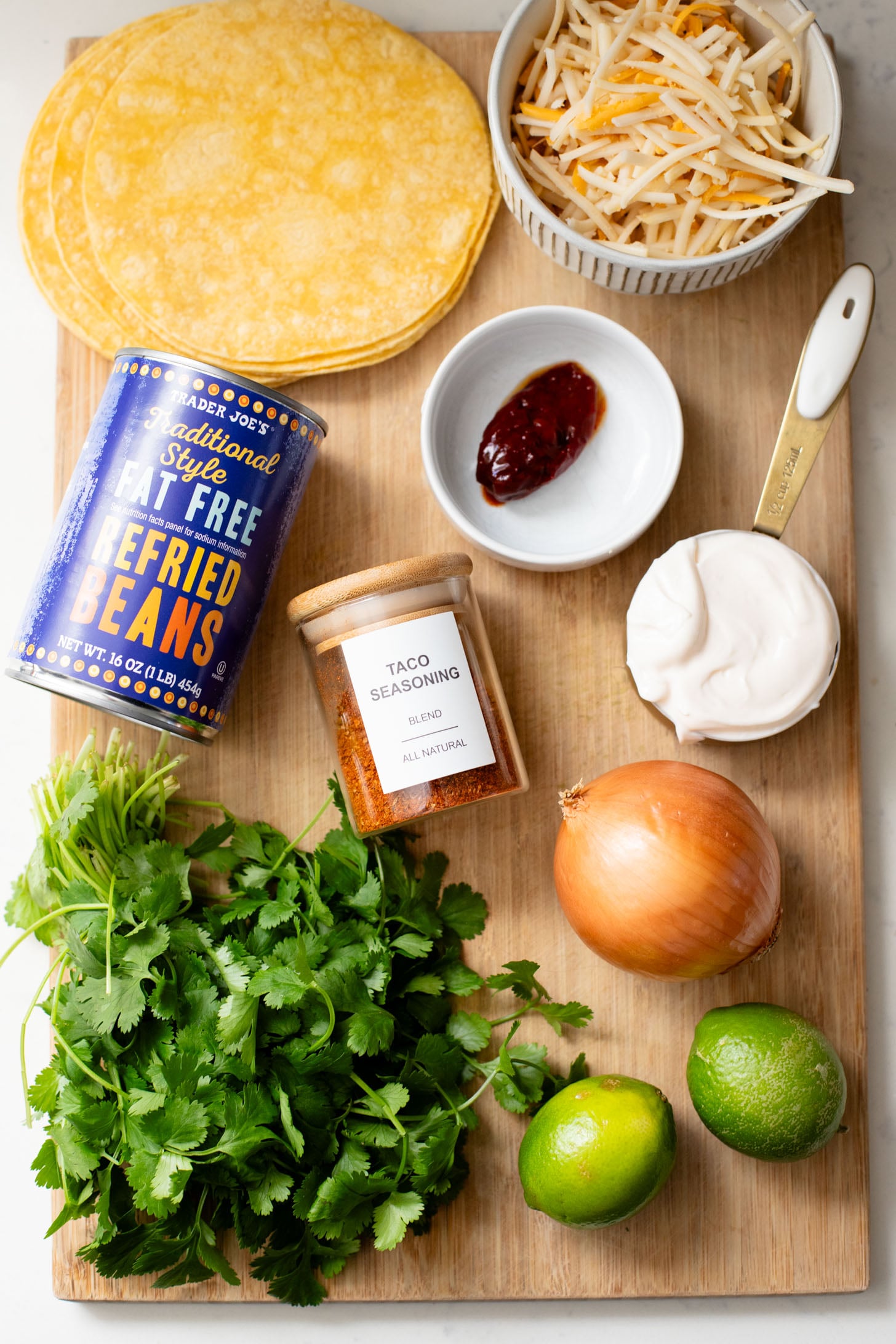 These Cheesy Bean Tacos are the perfect family weeknight dinner. Tortillas are stuffed with dairy-free cheese & beans and baked until crispy | ThisSavoryVegan.com