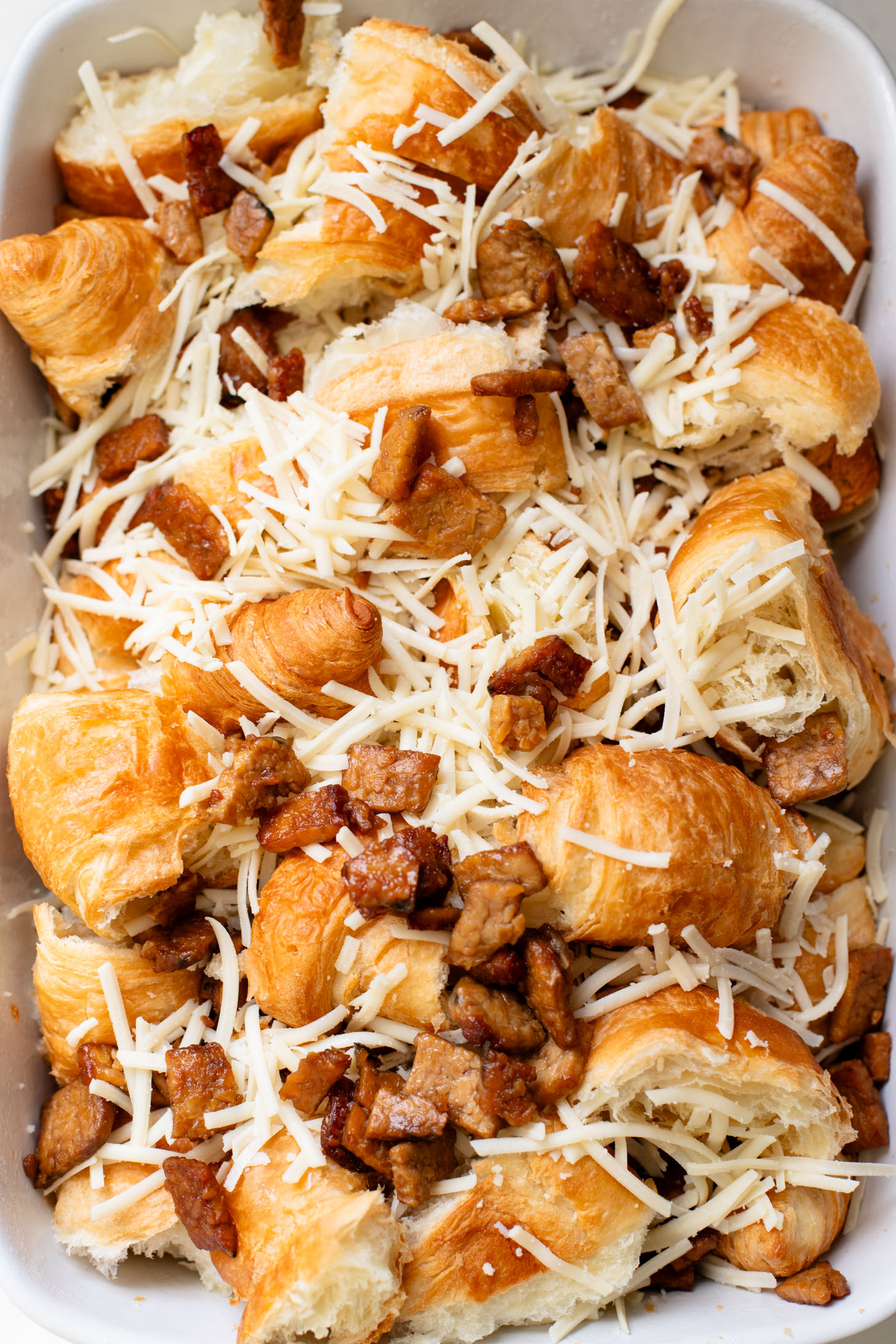 This Vegan Croissant Breakfast Casserole is made with flakey vegan croissants, tempeh bacon and vegan eggs | ThisSavoryVegan.com