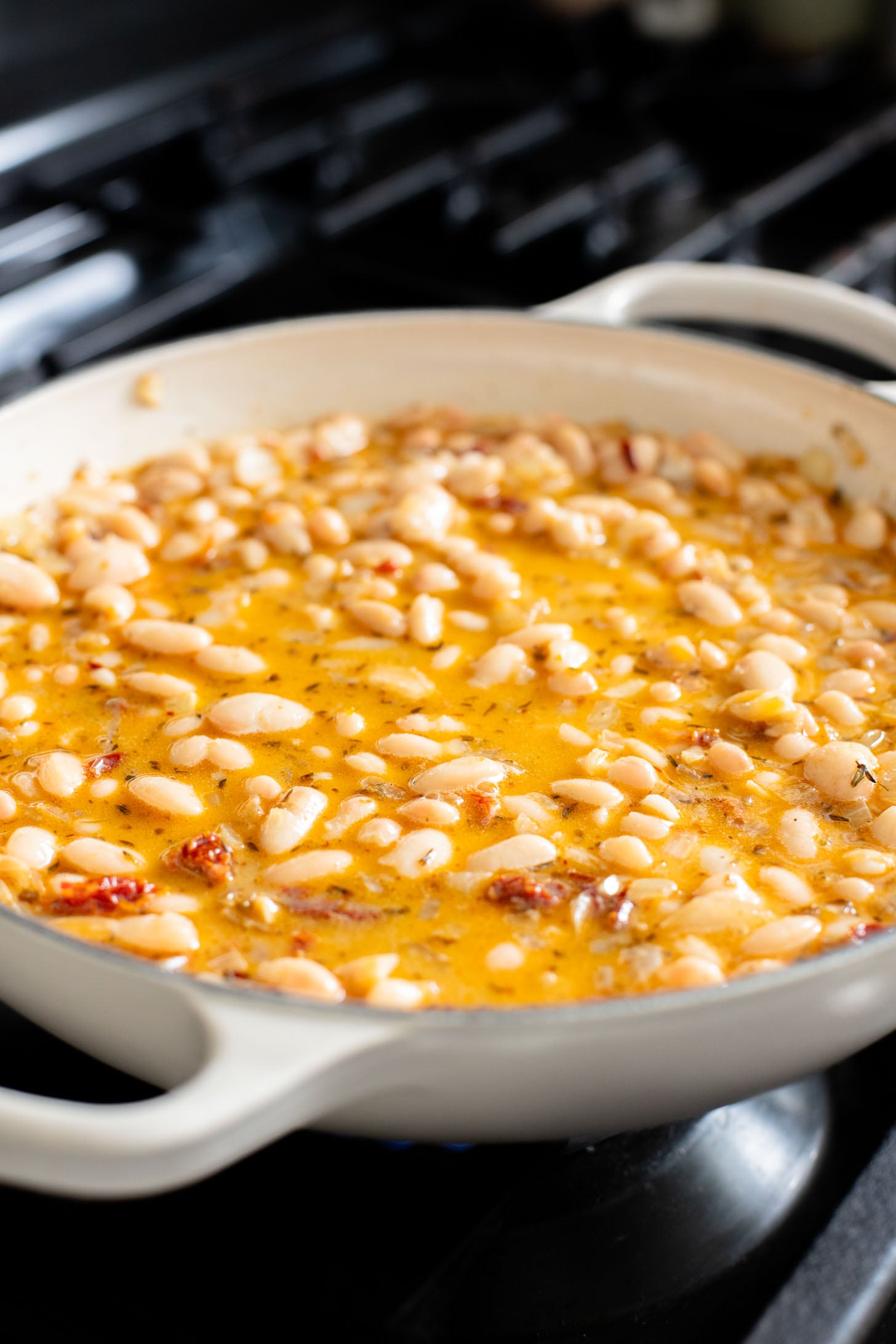 These Mediterranean White Beans are an easy, one-pot dinner that is ready in 30 minutes. Serve with bread for the perfect bite | ThisSavoryVegan.com