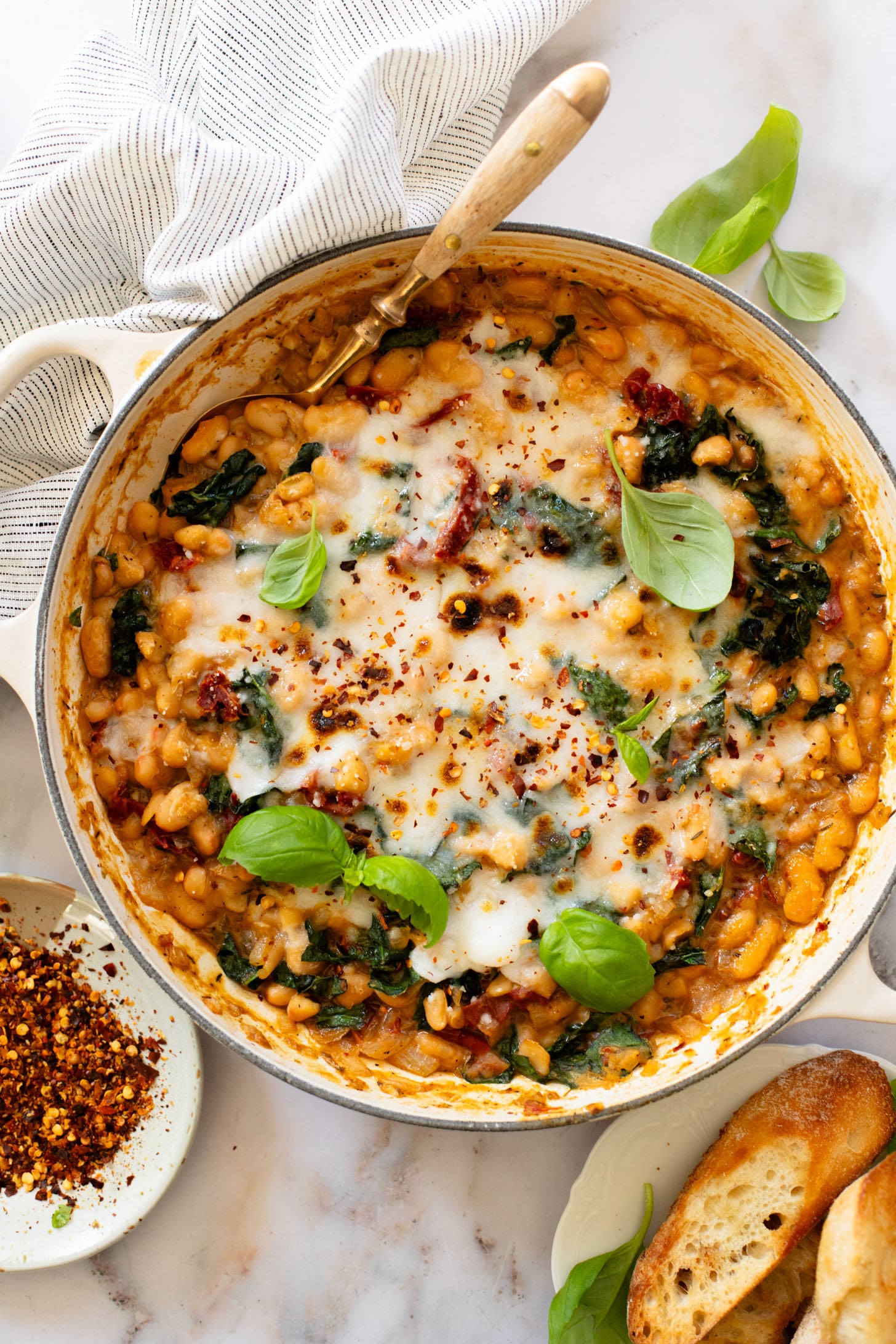 These Mediterranean White Beans are an easy, one-pot dinner that is ready in 30 minutes. Serve with bread for the perfect bite | ThisSavoryVegan.com