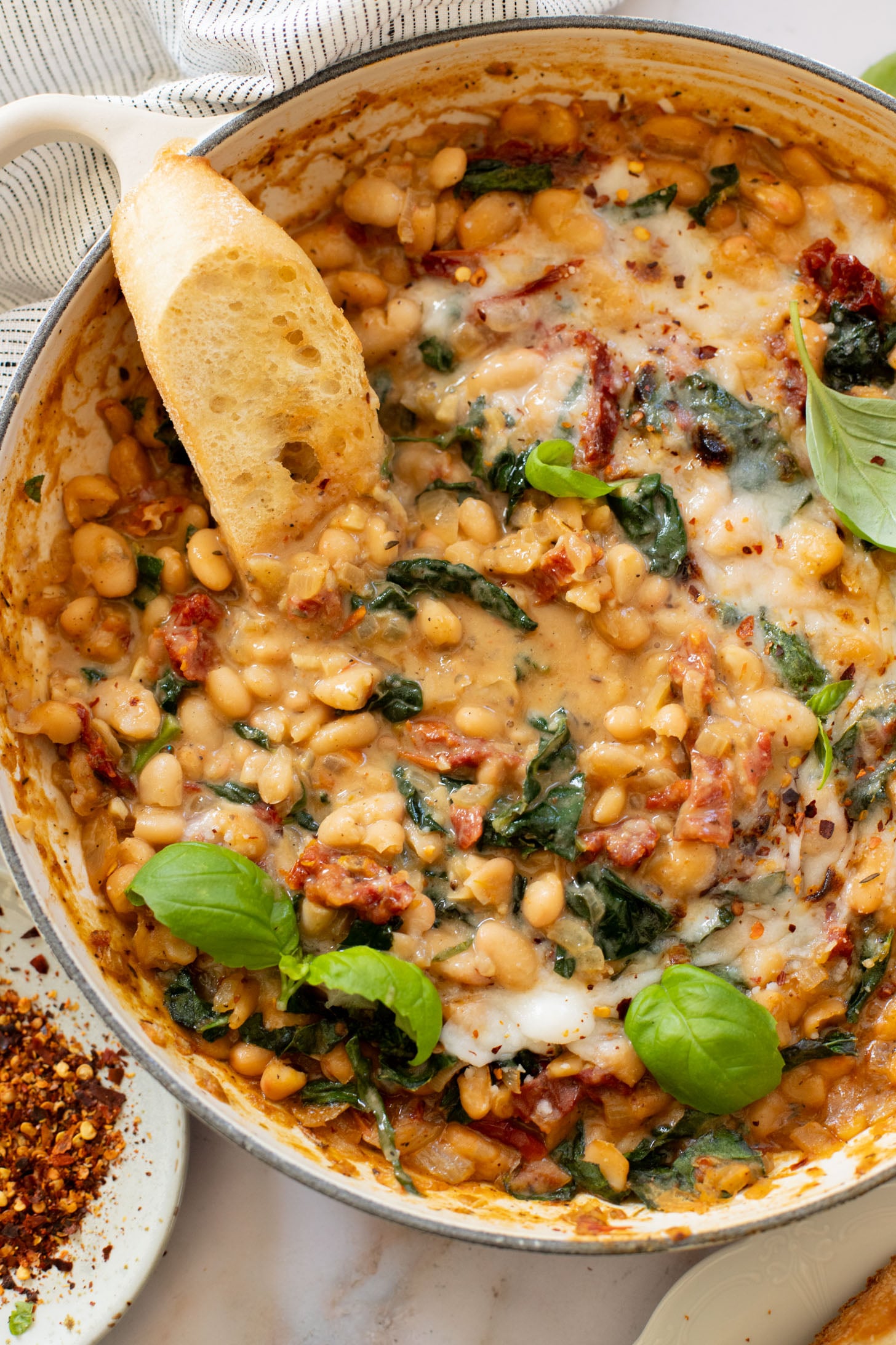 These Mediterranean White Beans are an easy, one-pot dinner that is ready in 30 minutes. Serve with bread for the perfect bite | ThisSavoryVegan.com