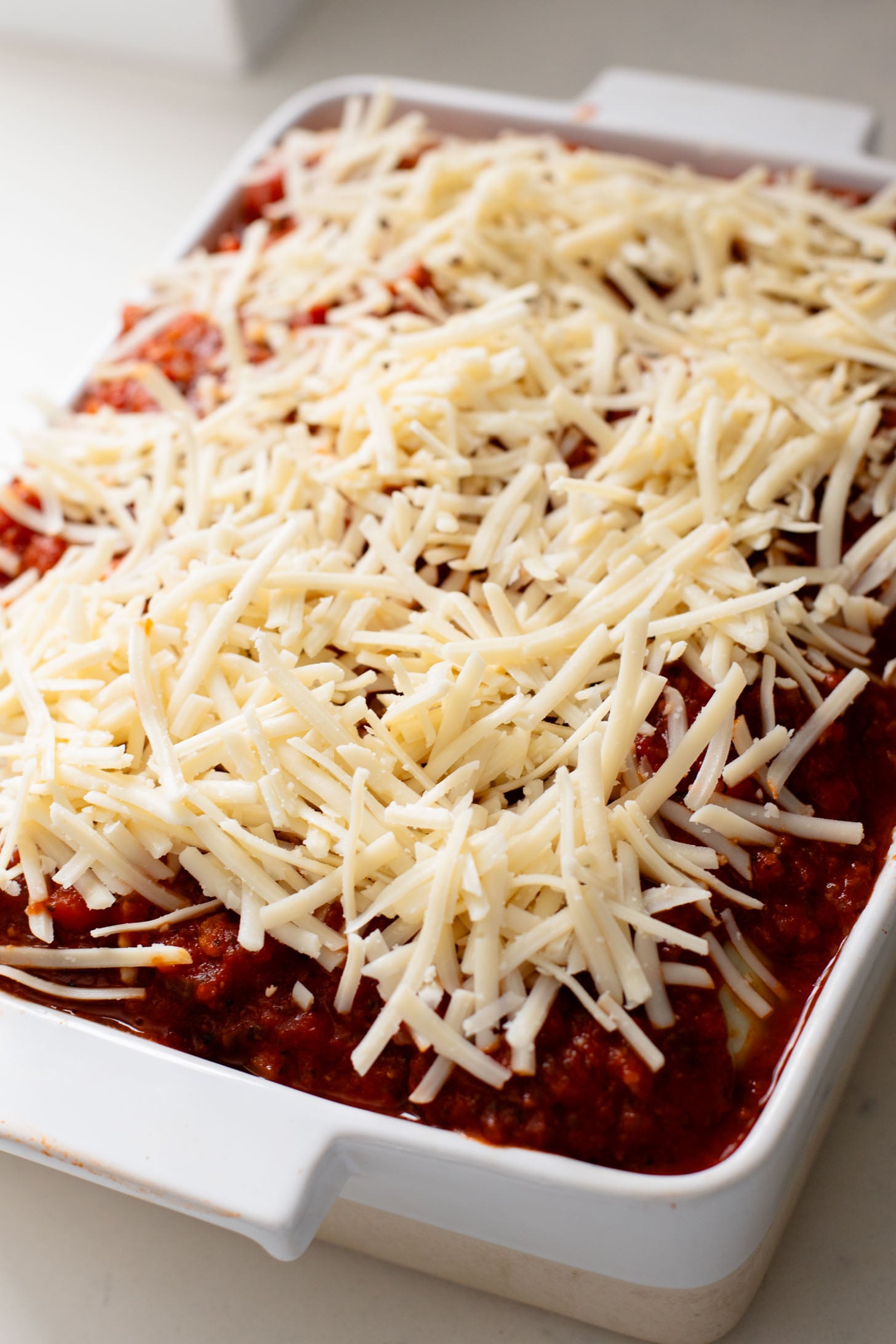 This Ravioli Lasagna is the ultimate family dinner! It is easy to assemble, feeds a crowd and is 100% dairy-free | ThisSavoryVegan.com