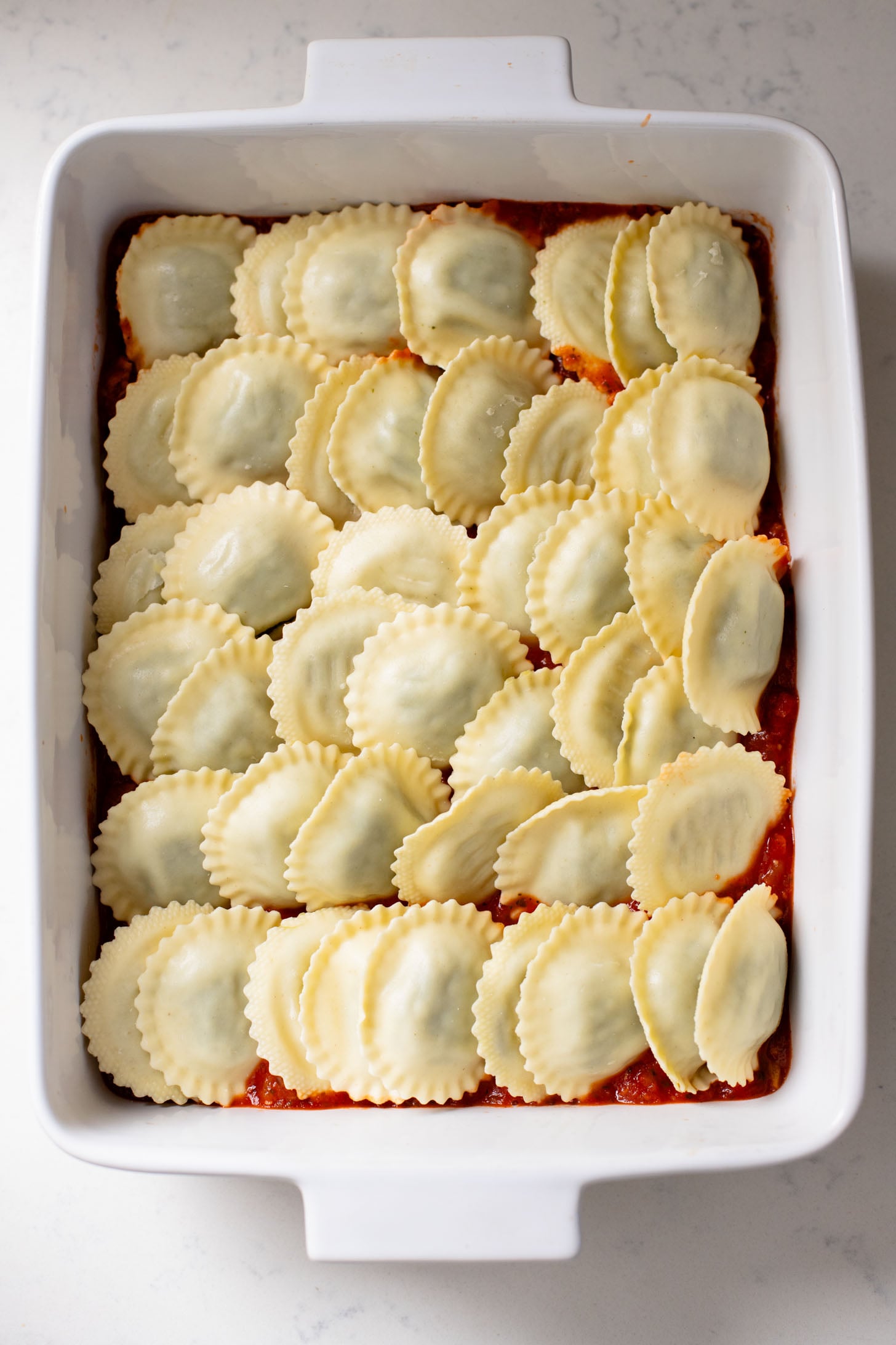 This Ravioli Lasagna is the ultimate family dinner! It is easy to assemble, feeds a crowd and is 100% dairy-free | ThisSavoryVegan.com