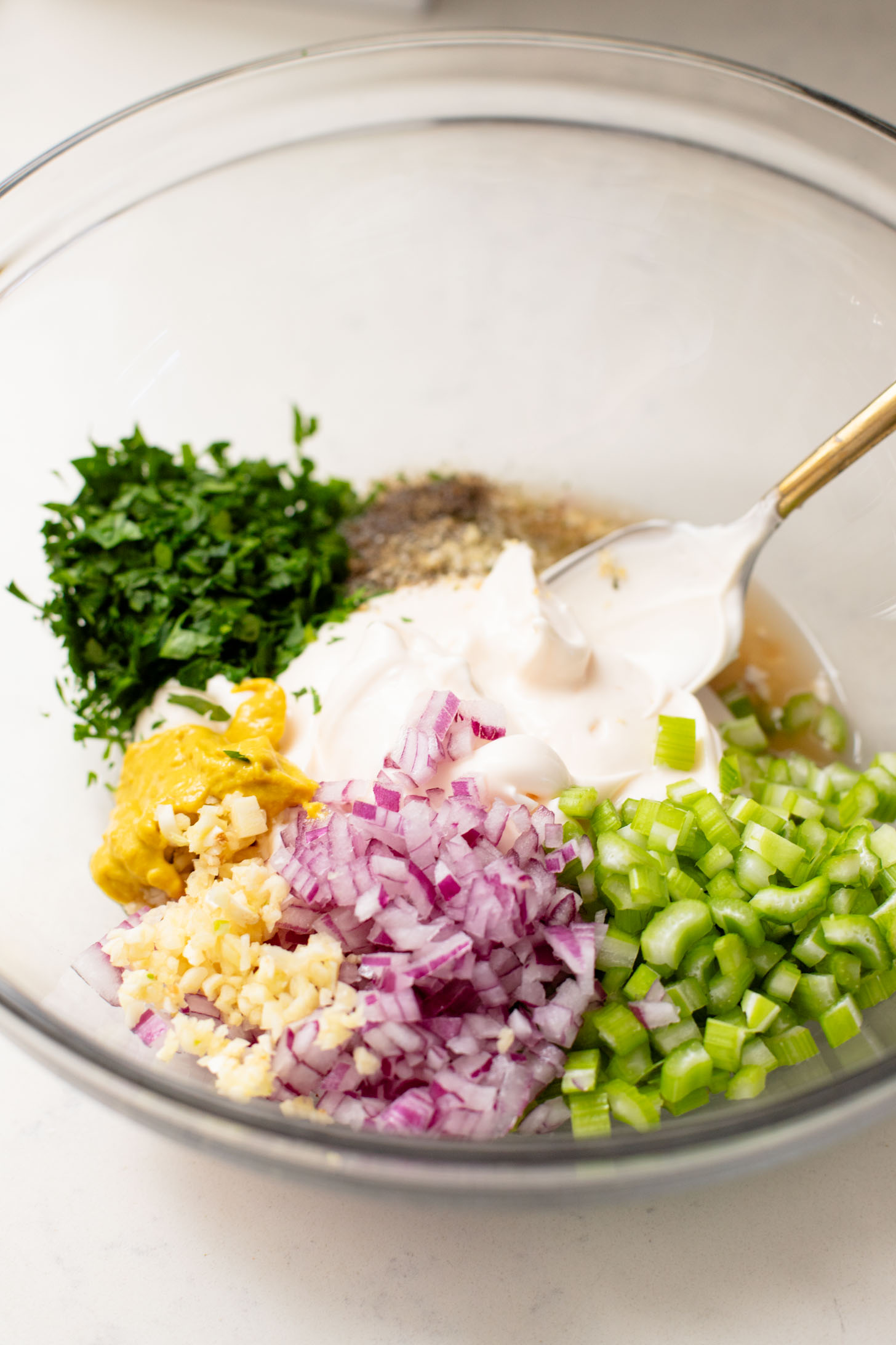 This Smashed Tater Tot Potato Salad is a party must make! The tots are crispy, the dressing is delicious and it is dairy-free | ThisSavoryVegan.com