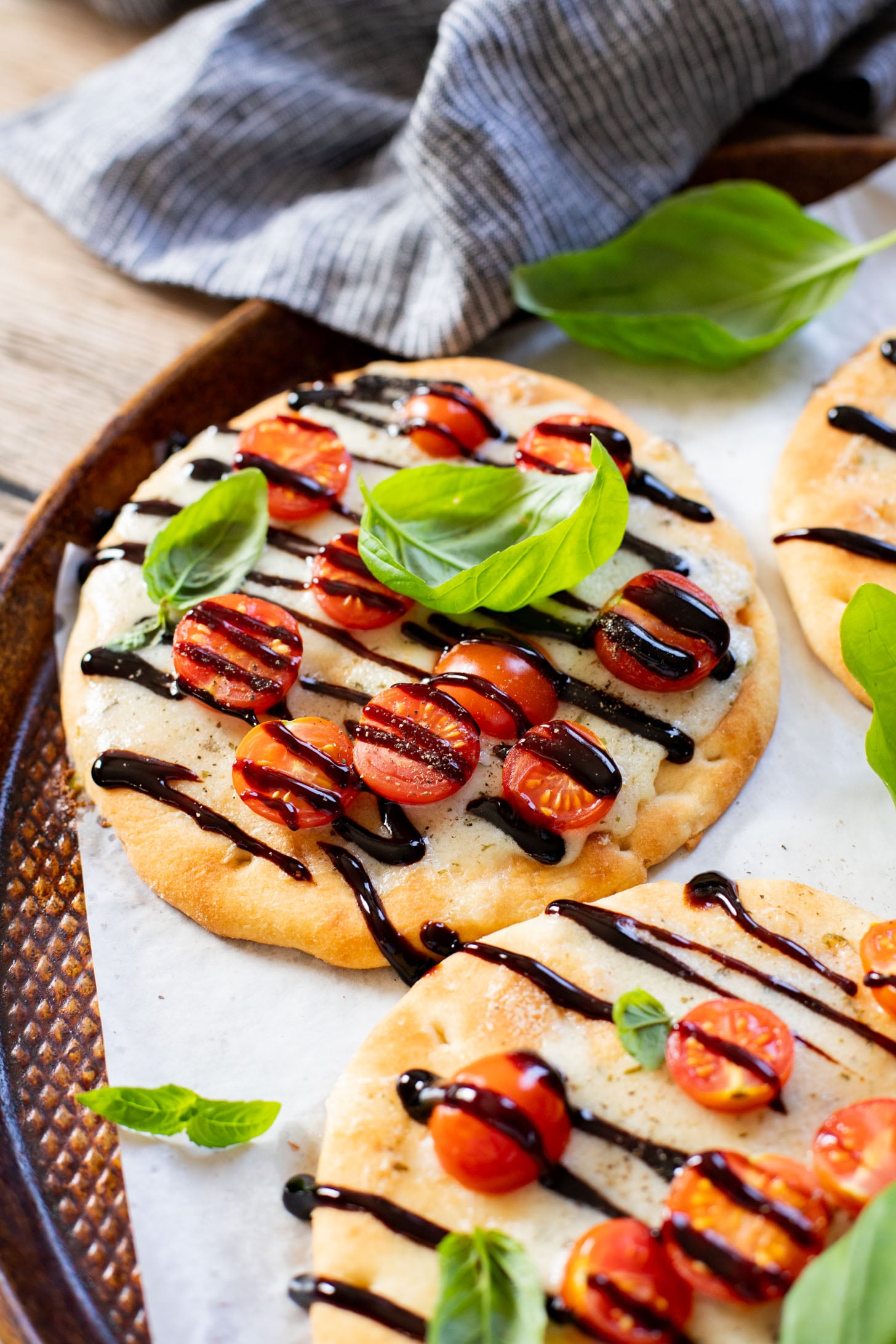 This Caprese Flatbread is a simple meal that packs in a ton of flavor. It is cheesy (and dairy-free), crispy, and simply delicious | ThisSavoryVegan.com