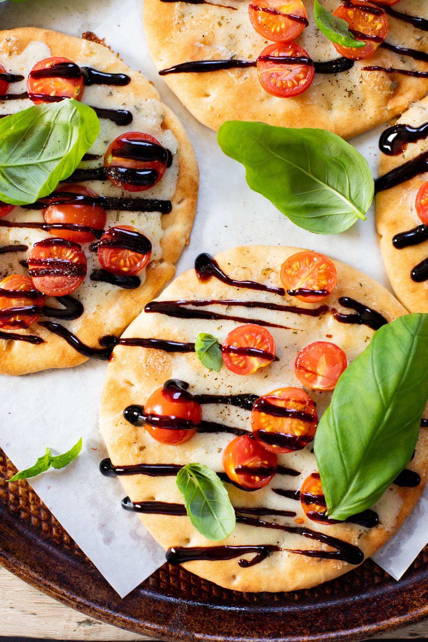 This Caprese Flatbread is a simple meal that packs in a ton of flavor. It is cheesy (and dairy-free), crispy, and simply delicious | ThisSavoryVegan.com