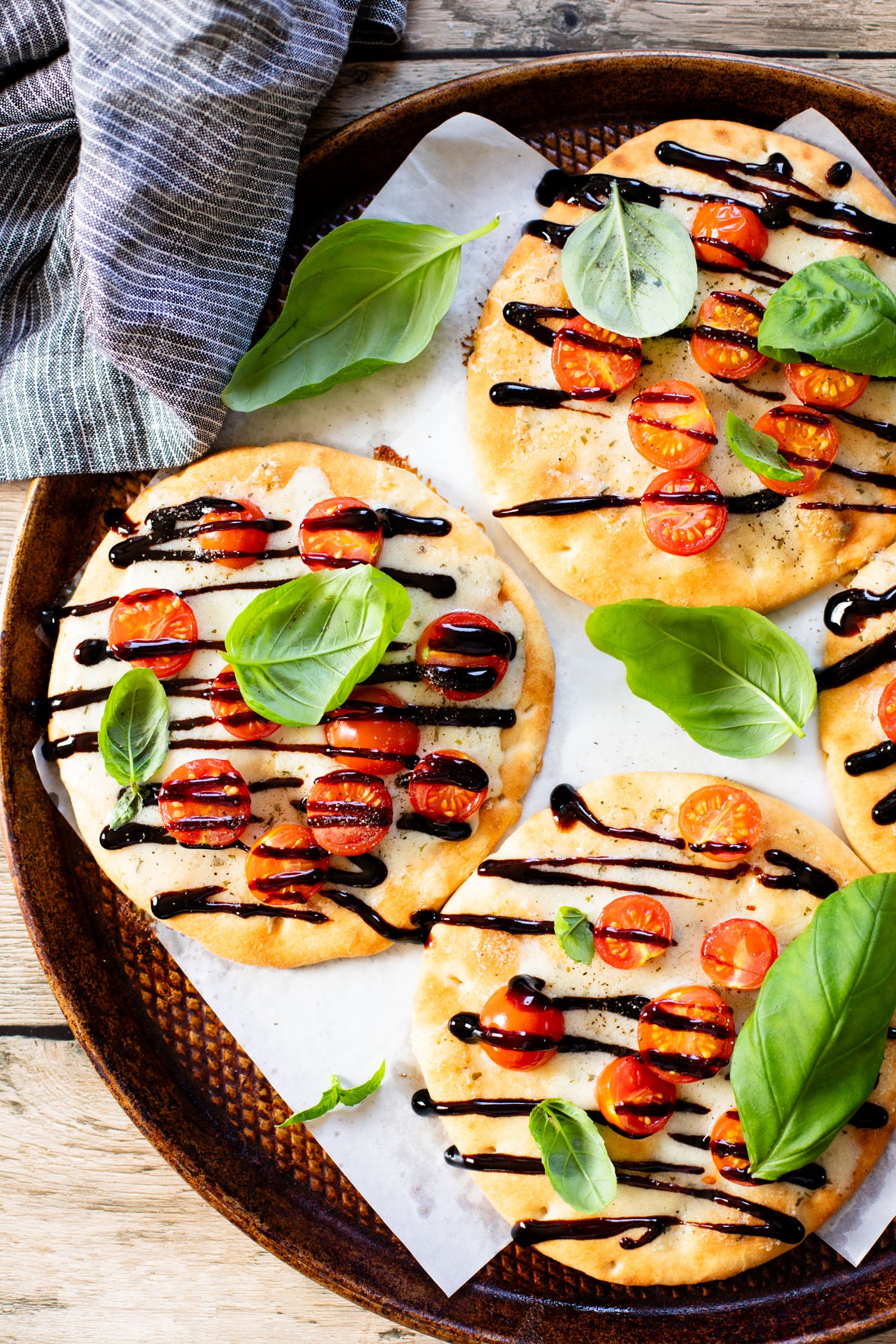 This Caprese Flatbread is a simple meal that packs in a ton of flavor. It is cheesy (and dairy-free), crispy, and simply delicious | ThisSavoryVegan.com