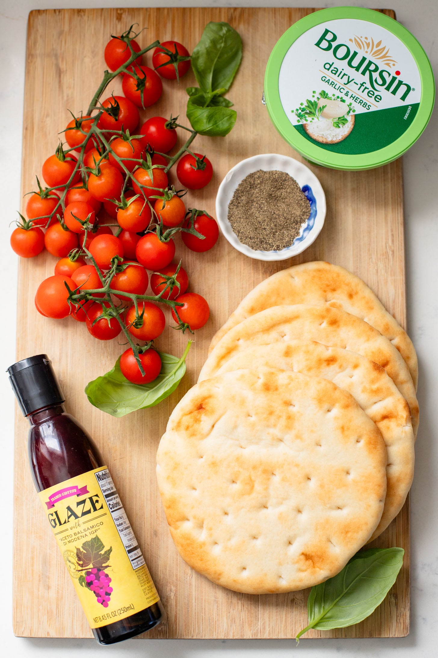 This Caprese Flatbread is a simple meal that packs in a ton of flavor. It is cheesy (and dairy-free), crispy, and simply delicious | ThisSavoryVegan.com