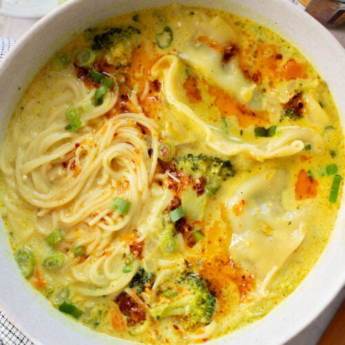 This Curried Coconut Wonton Soup has a dairy-free, creamy broth, plenty of veggies, rice noodles and vegan wontons | ThisSavoryVegan.com