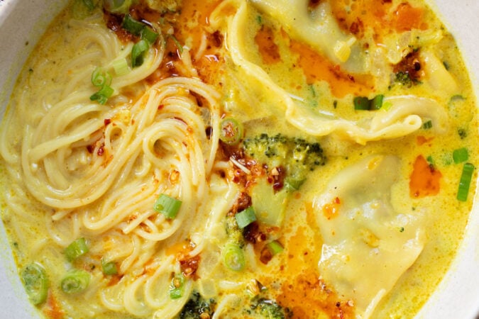 This Curried Coconut Wonton Soup has a dairy-free, creamy broth, plenty of veggies, rice noodles and vegan wontons | ThisSavoryVegan.com
