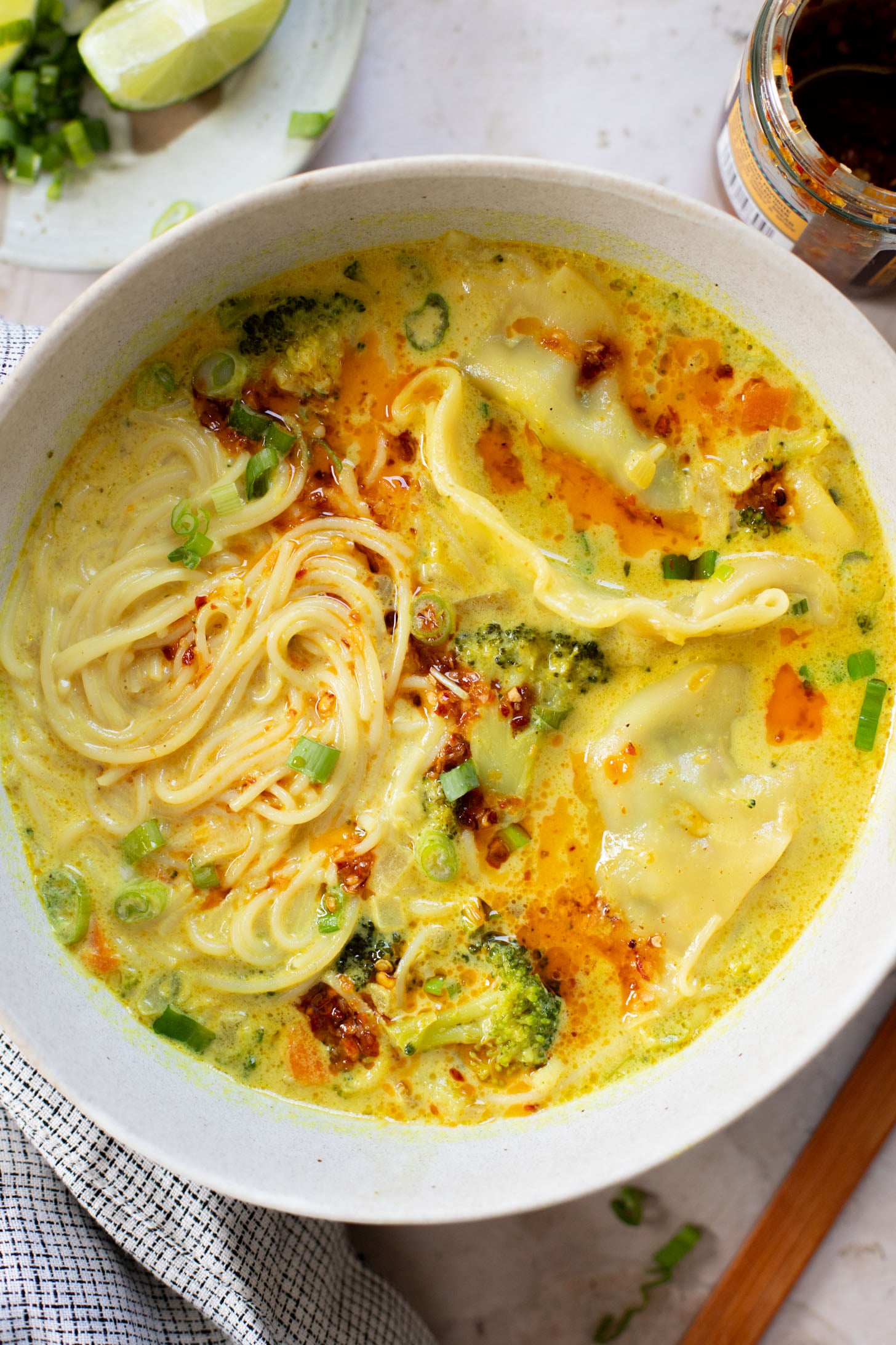 This Curried Coconut Wonton Soup has a dairy-free, creamy broth, plenty of veggies, rice noodles and vegan wontons | ThisSavoryVegan.com